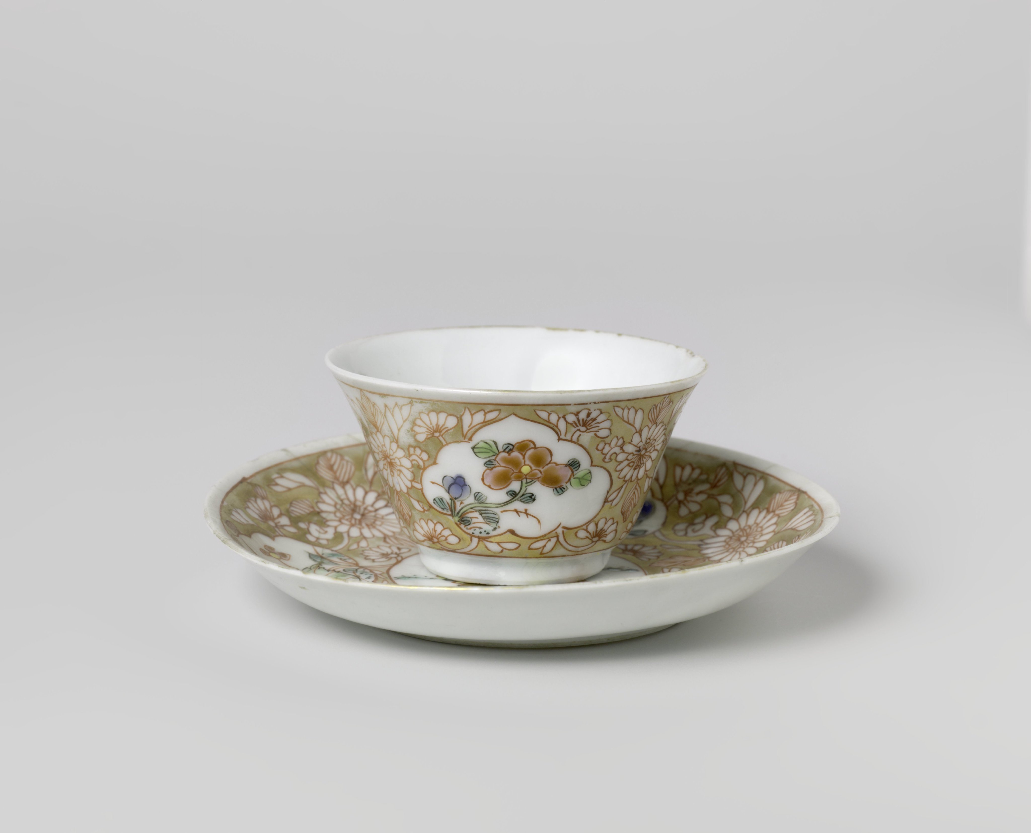 Cup and saucer with a woman with flower basket and flowering plants in panels