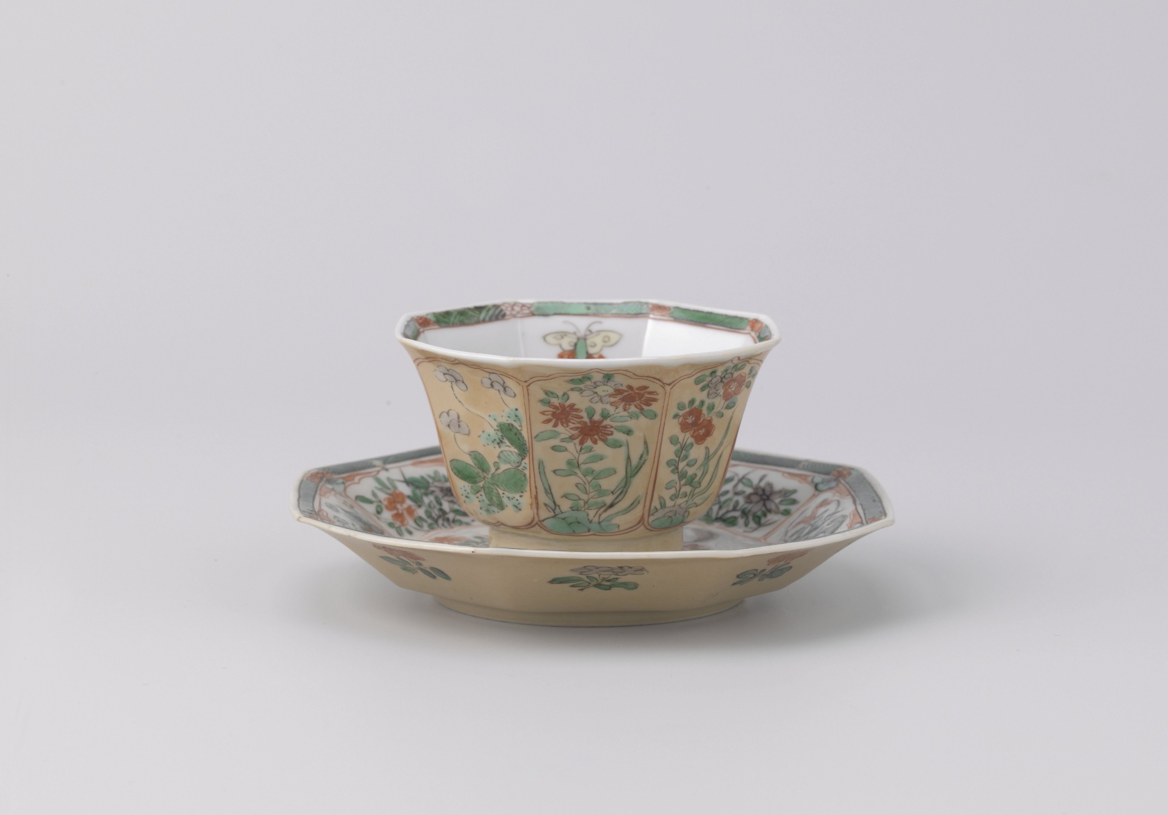 Octagonal cup and saucer with light brown, animals and flower sprays