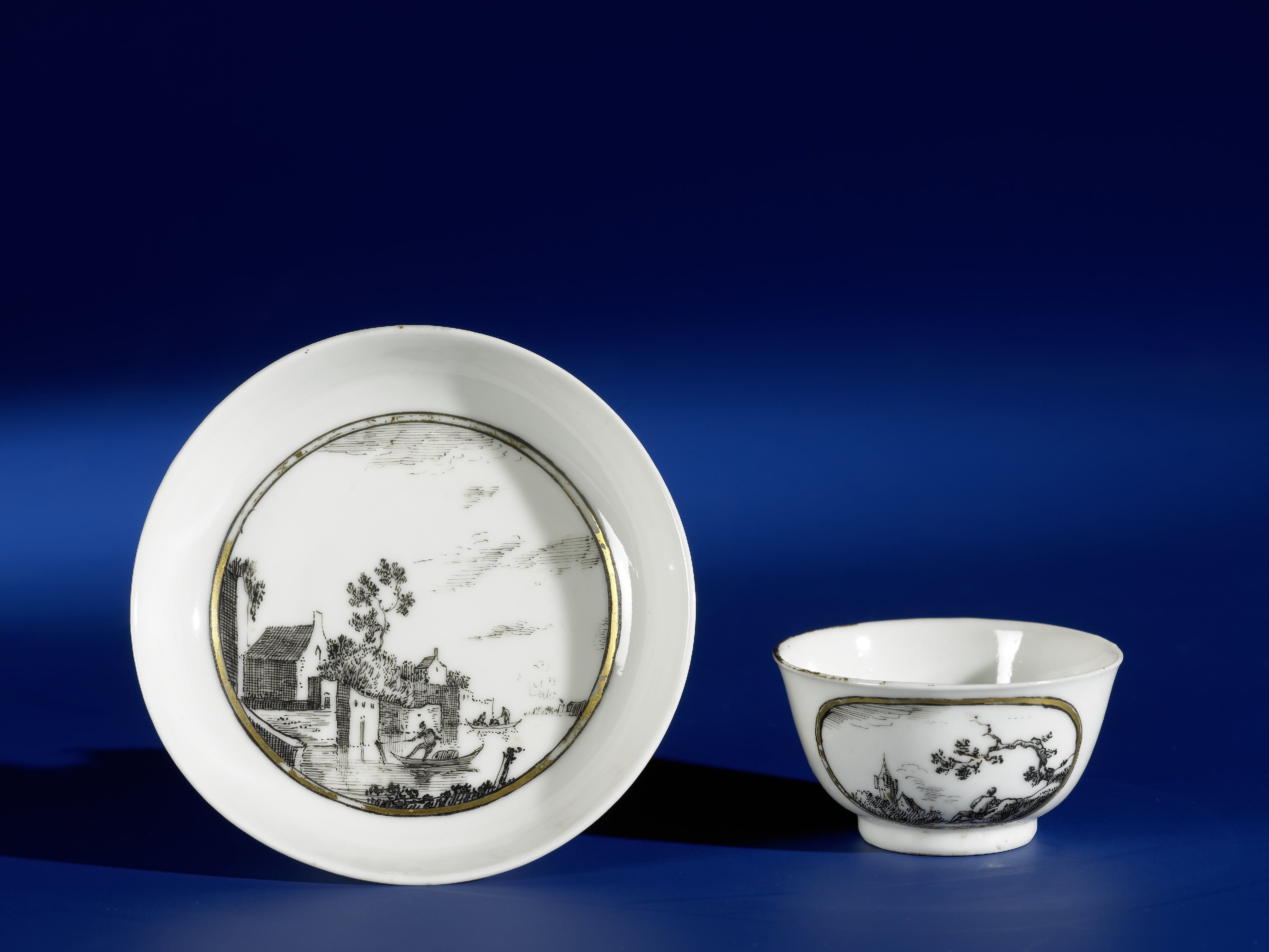 Bell-shaped cup and saucer with European landschapes in medallions
