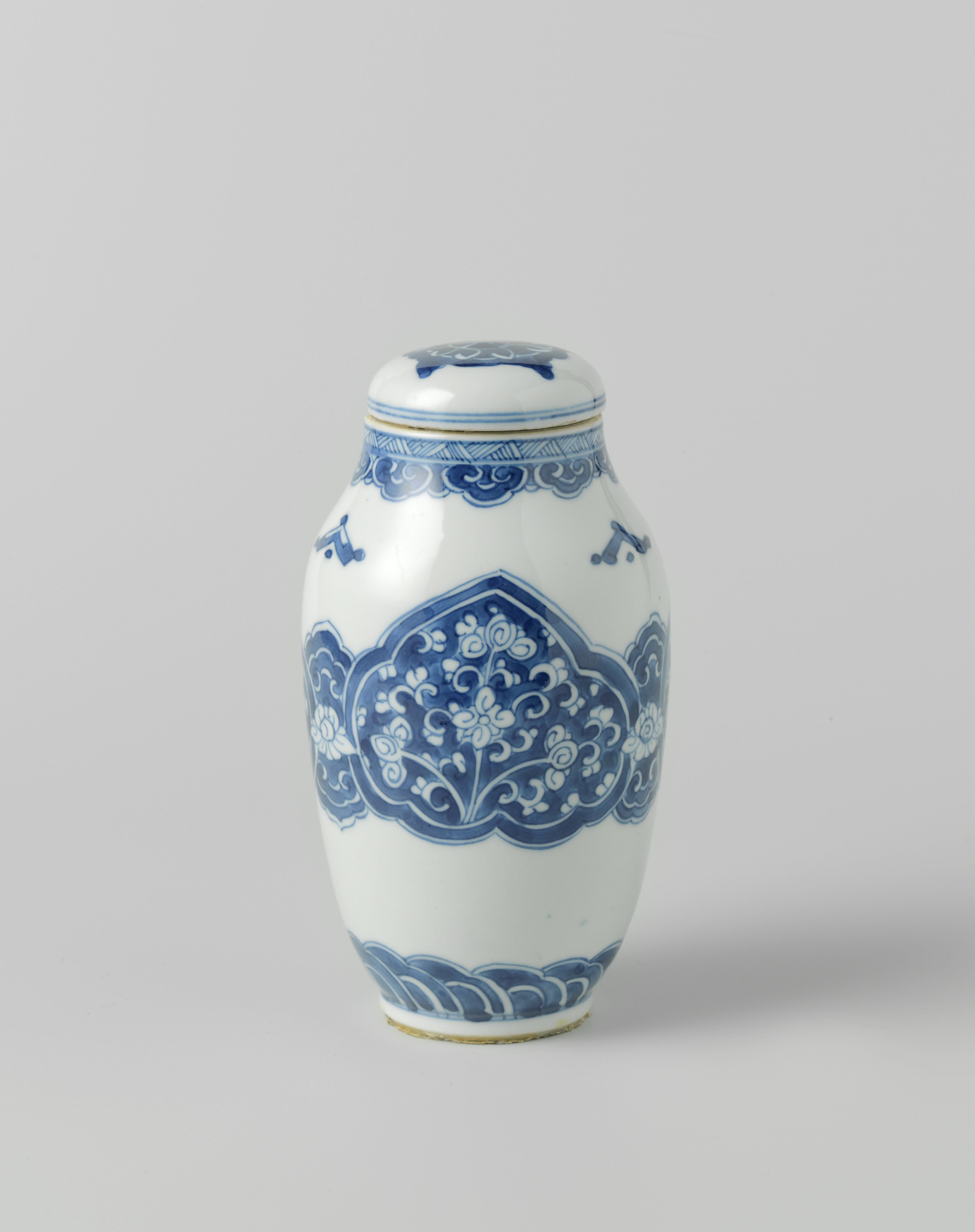 Ovoid covered jar with floral scrolls in reserve in ruyi-shaped panels
