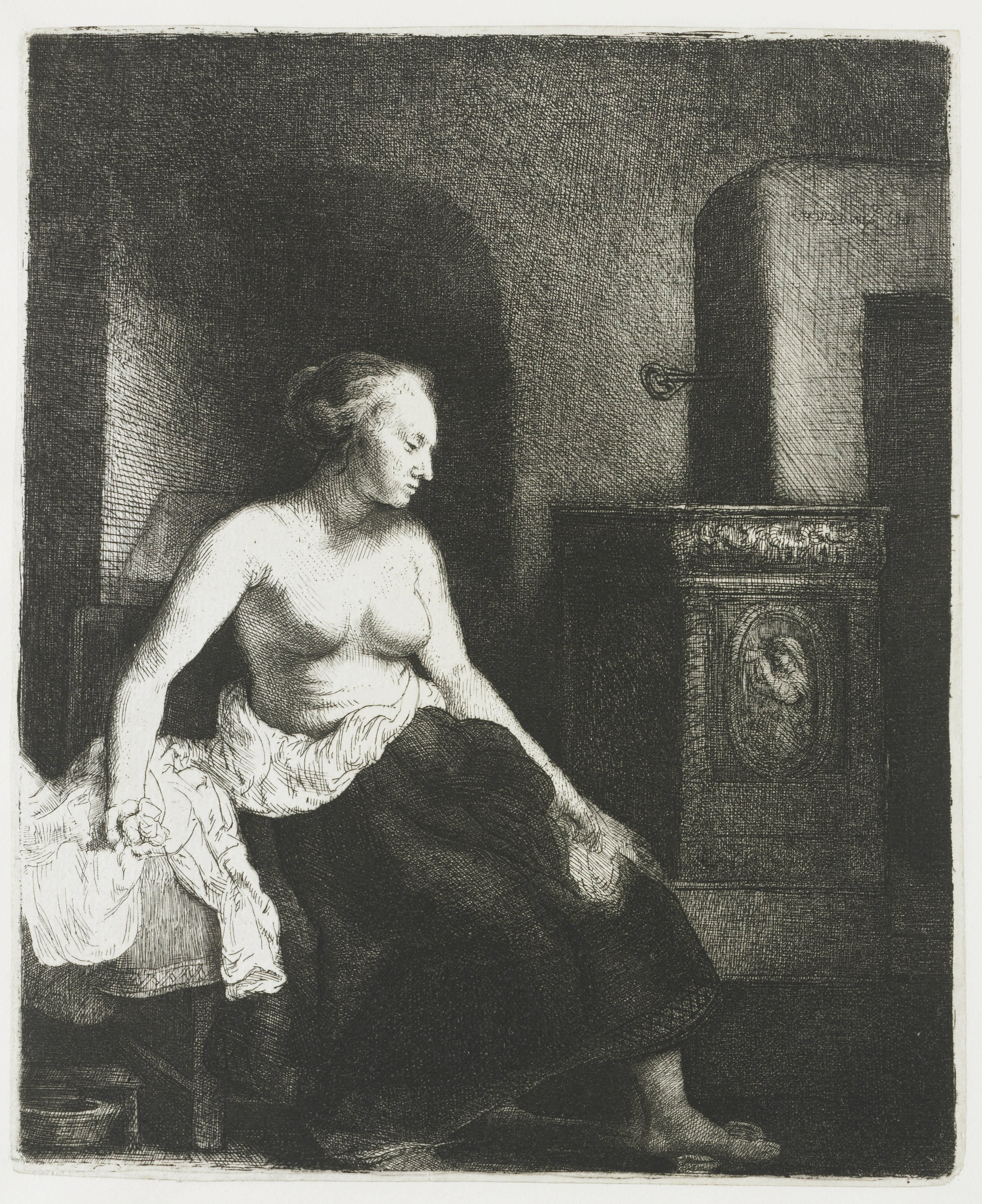 Woman sitting half dressed beside a stove