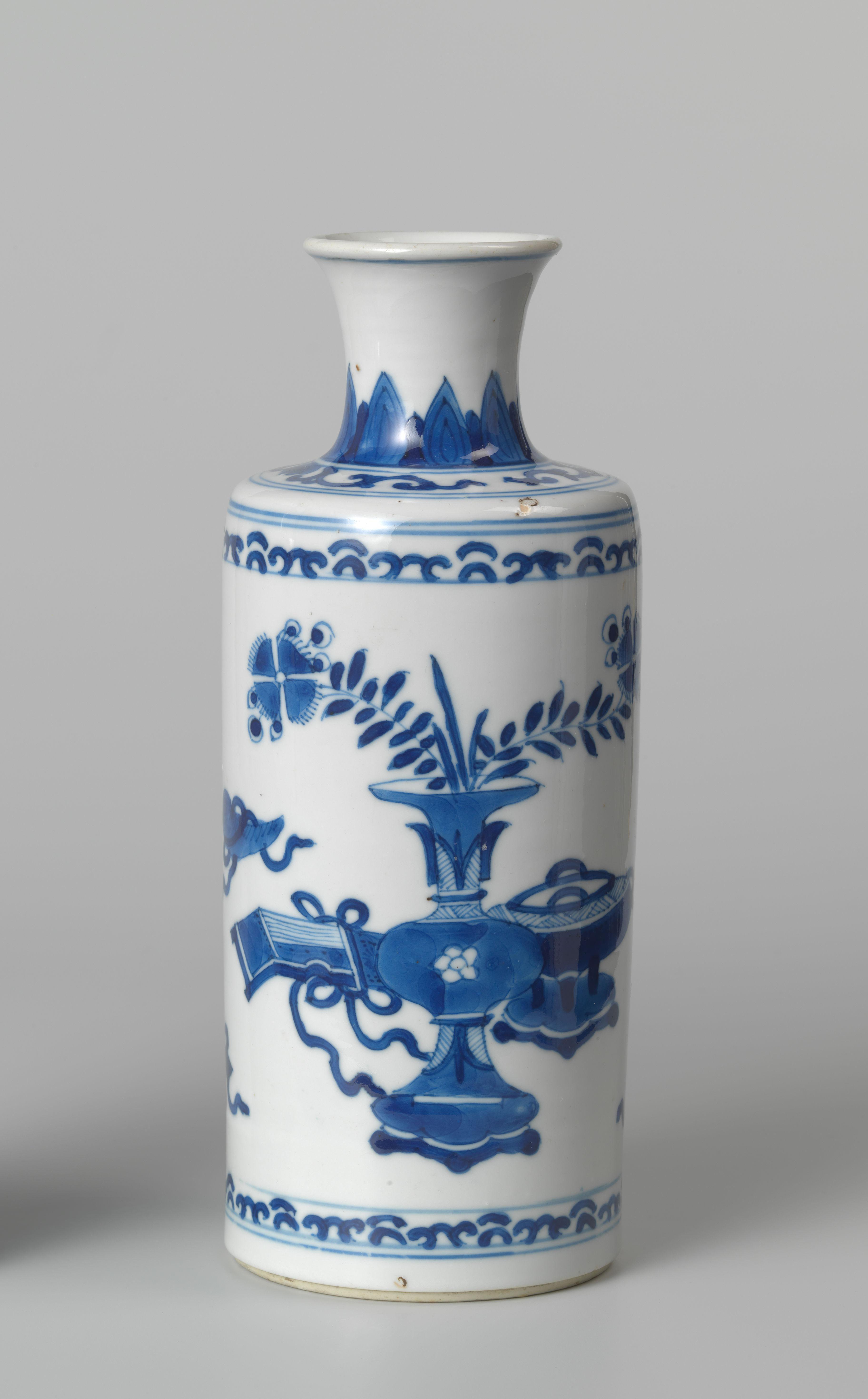 Cylindrical bottle vase with precious objects and foliate scrolls