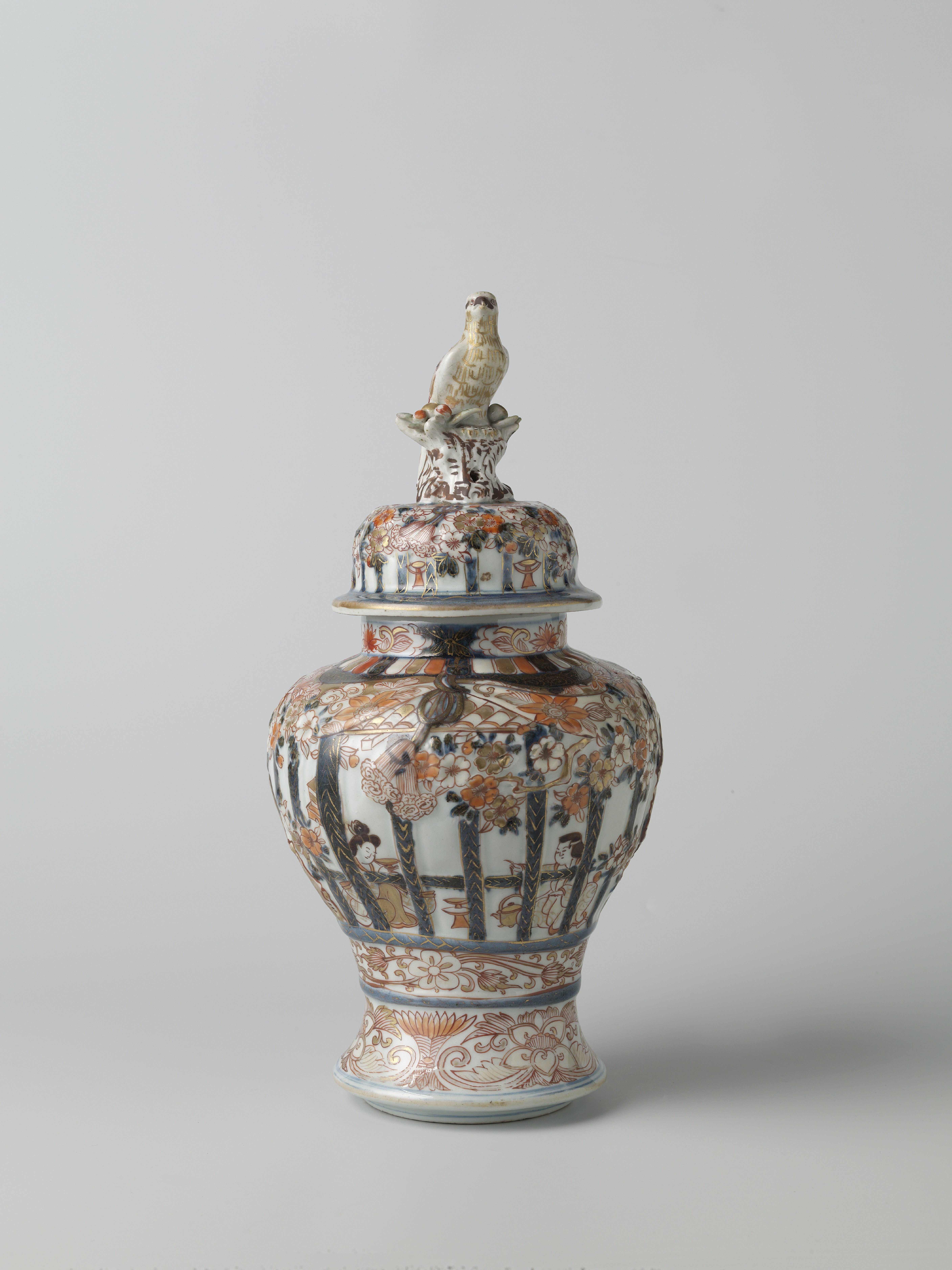 Covered baluster jar with figures in an interior behind framework, prunus trees and floral scrolls