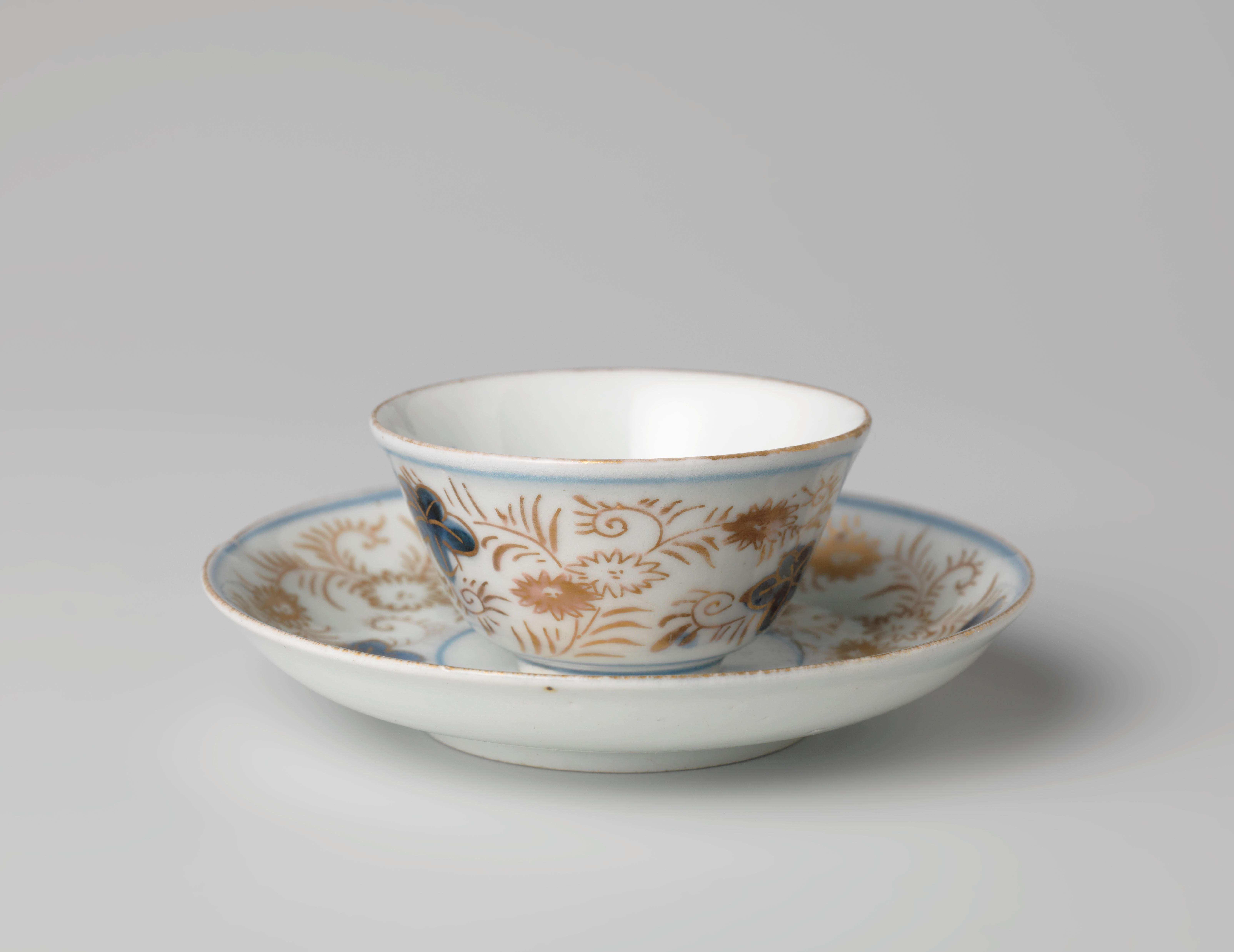 Bell-shaped cup and saucer with a flower basket and floral scrolls