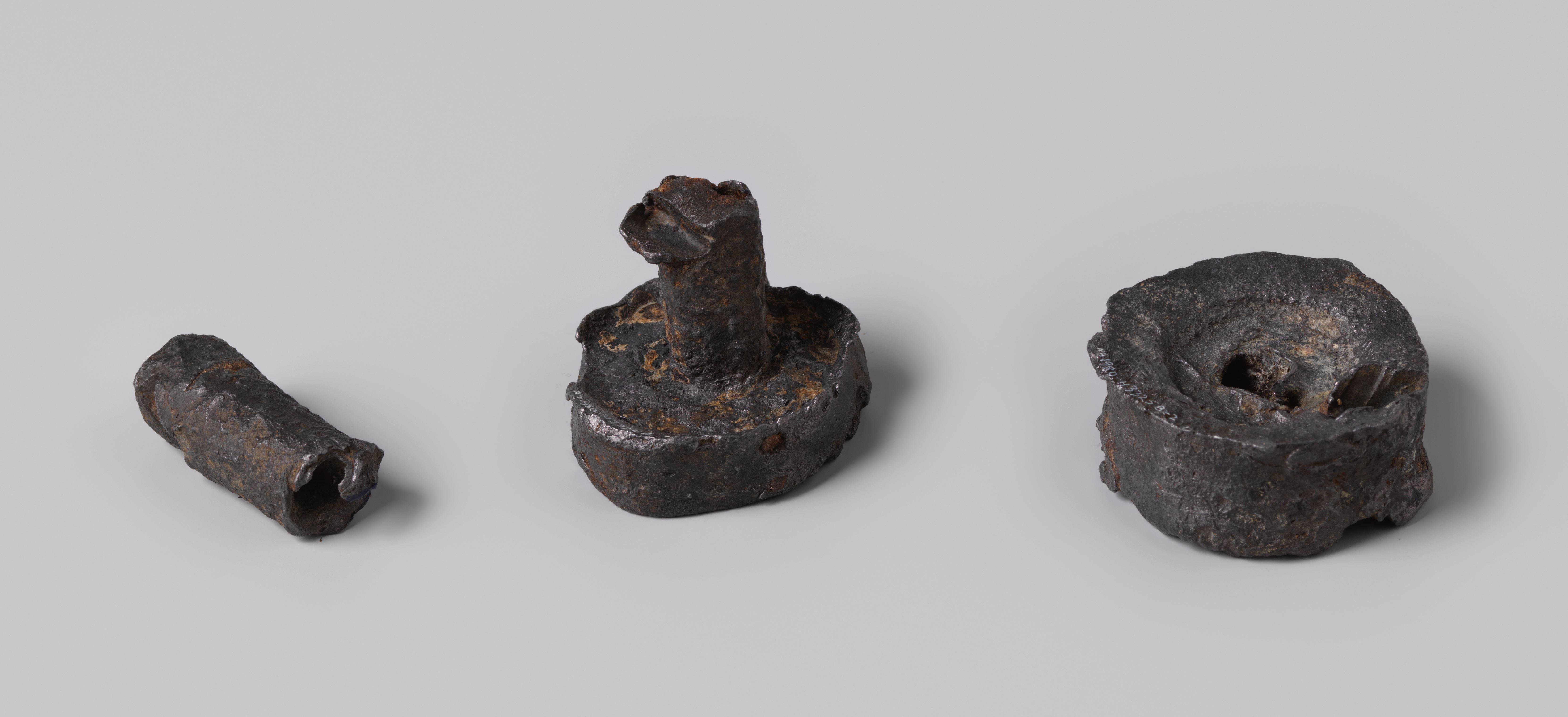 Two lead weights from the wreck of the Dutch East India ship Hollandia with the coat of arms of Amsterdam and the year 1743
