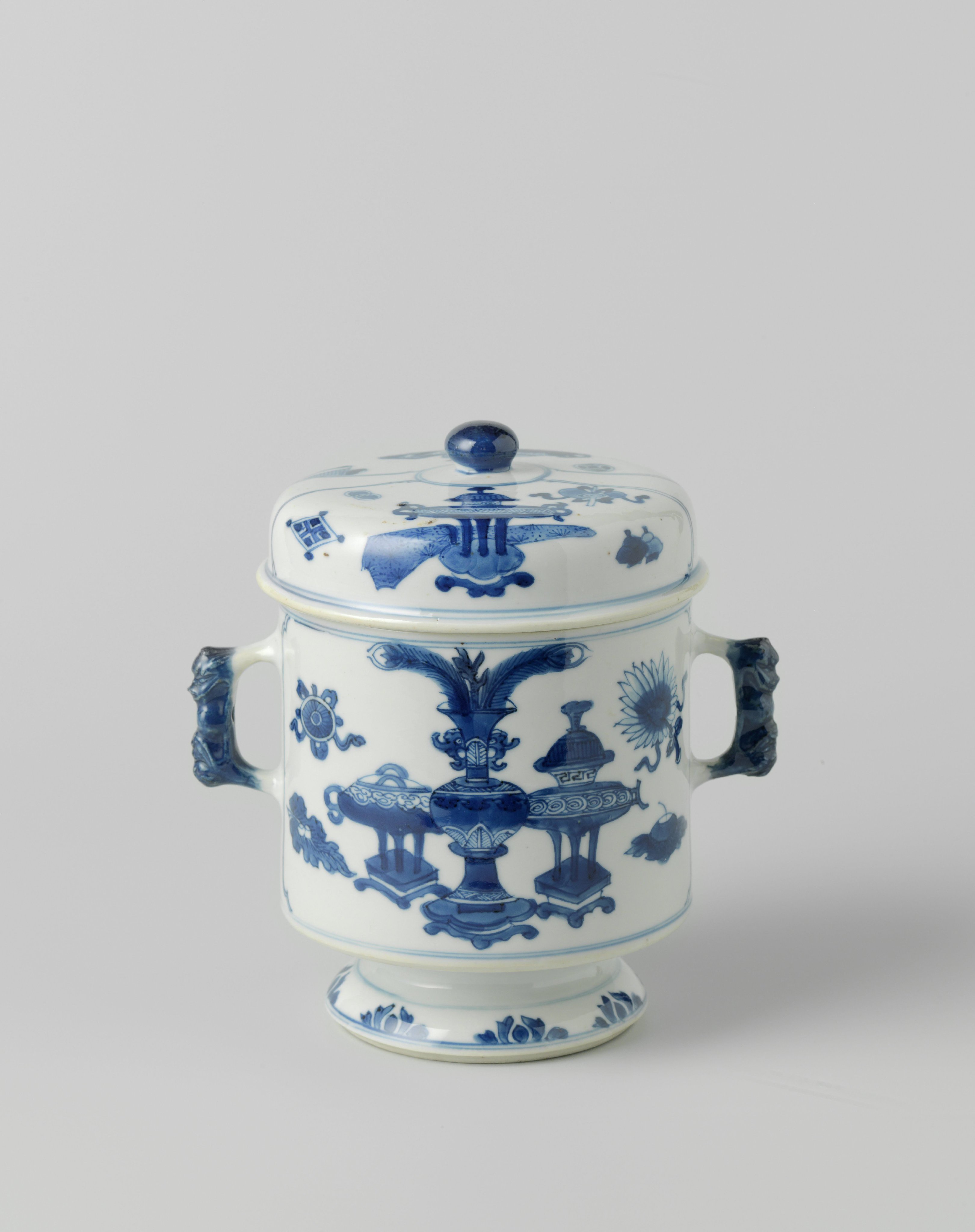 Cylindrical covered jar on foot with precious objects and antiquities