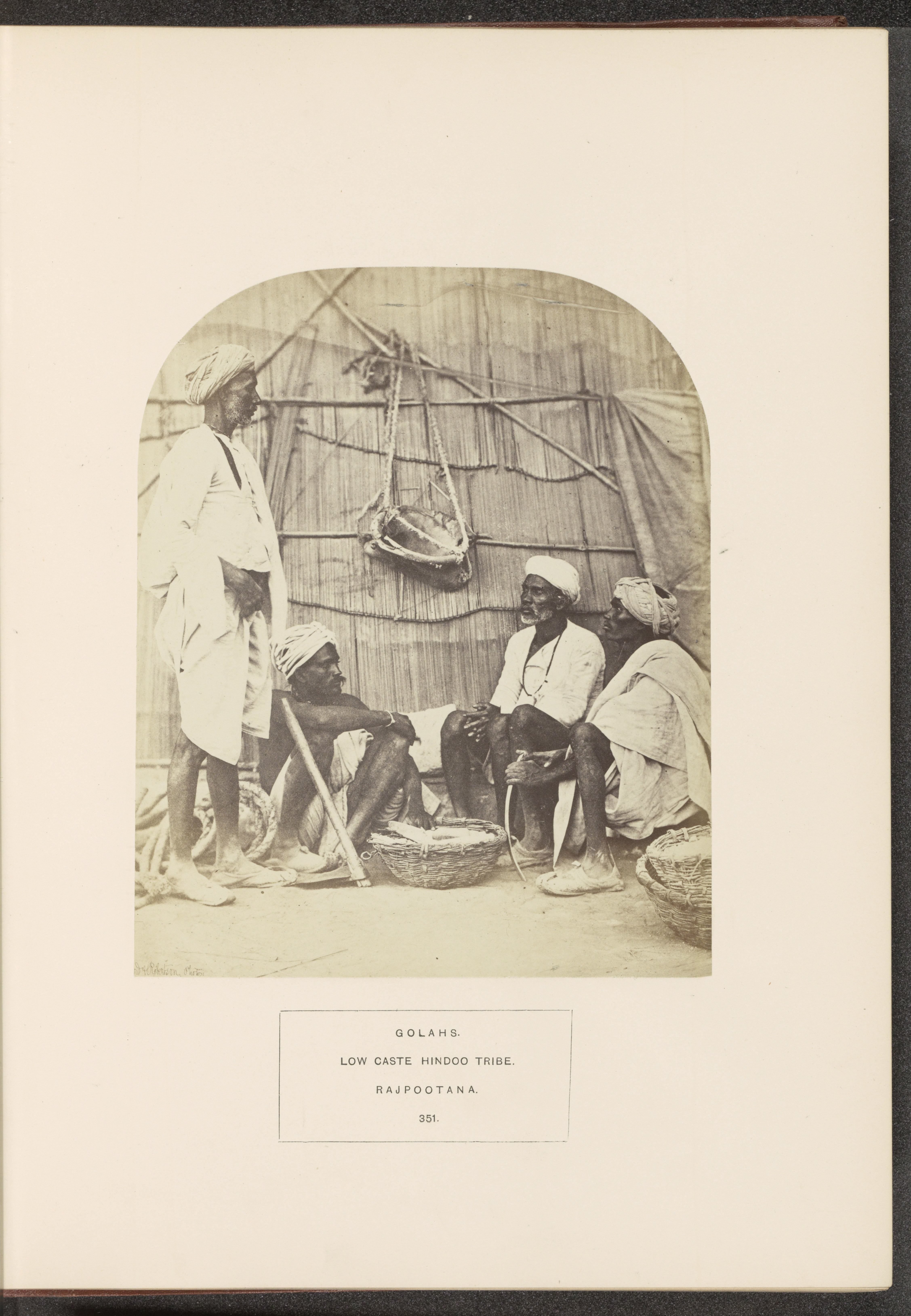 Four men from the Gola tribe around a basket with salt, India
