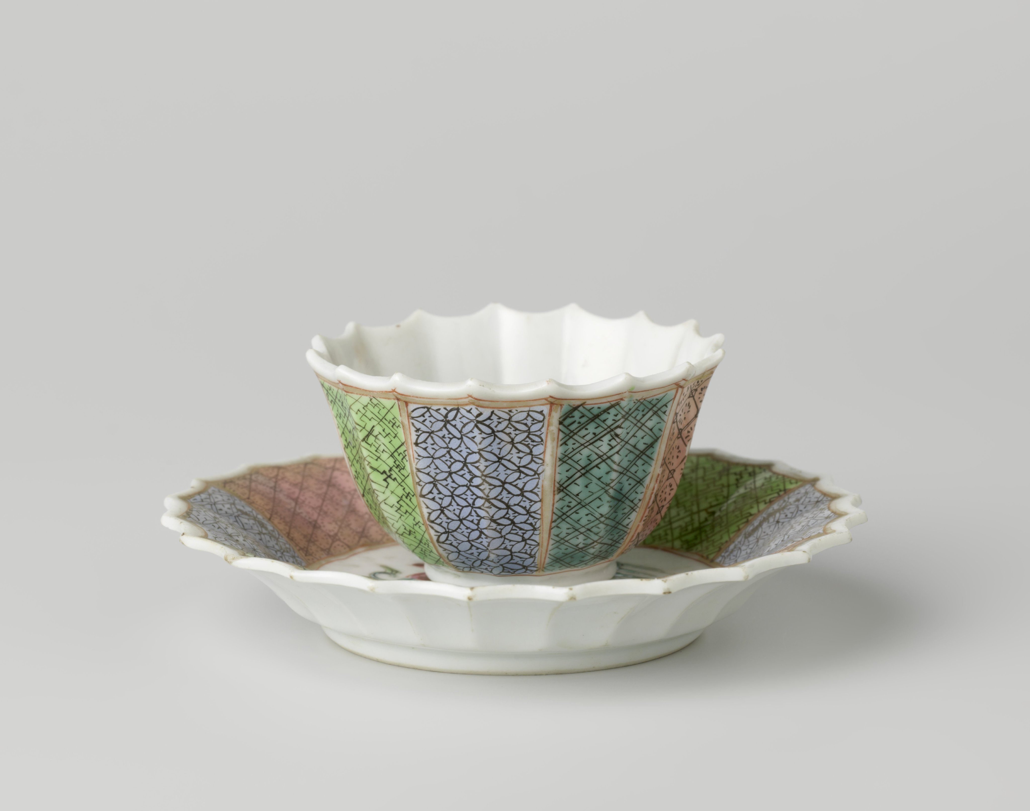 Bell-shaped cup and saucer with a putto holding a lotusbranch