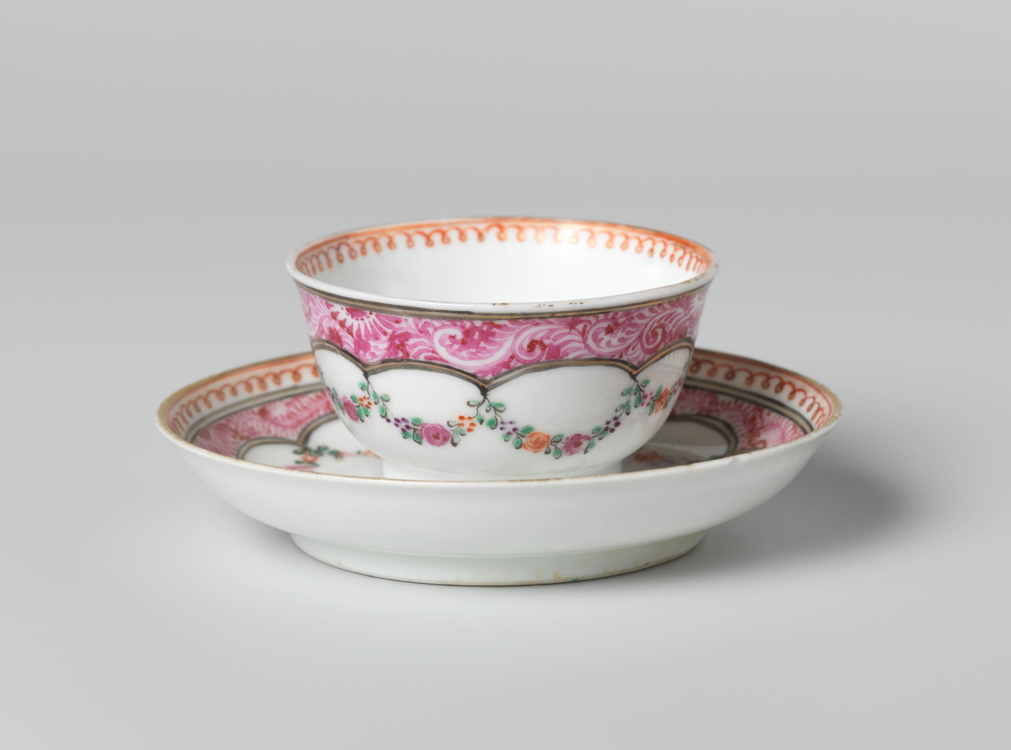 Bell-shaped cup and saucer with a flower group and garlands