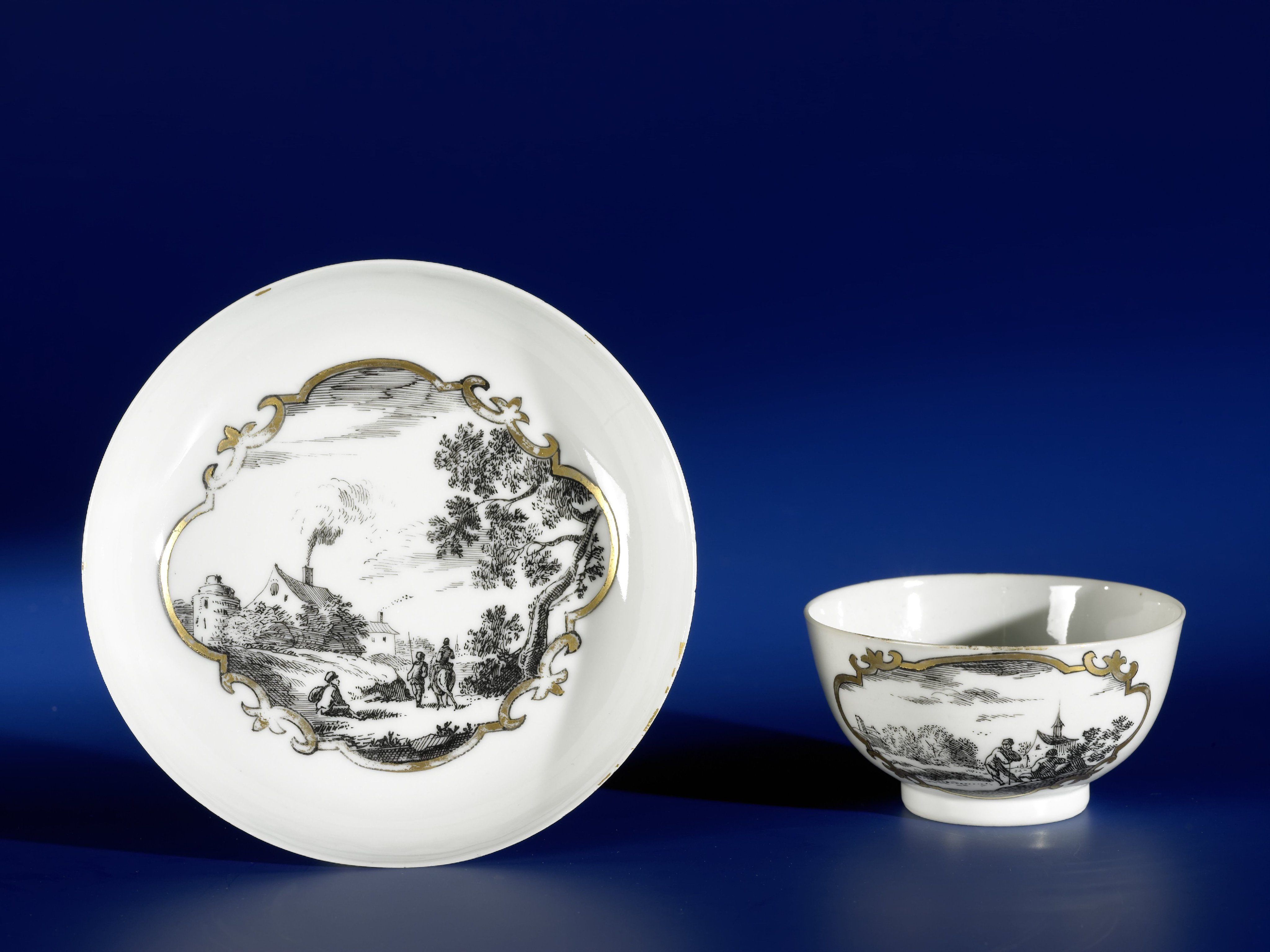 Straight-sided cup and saucer with European landscapes in panels