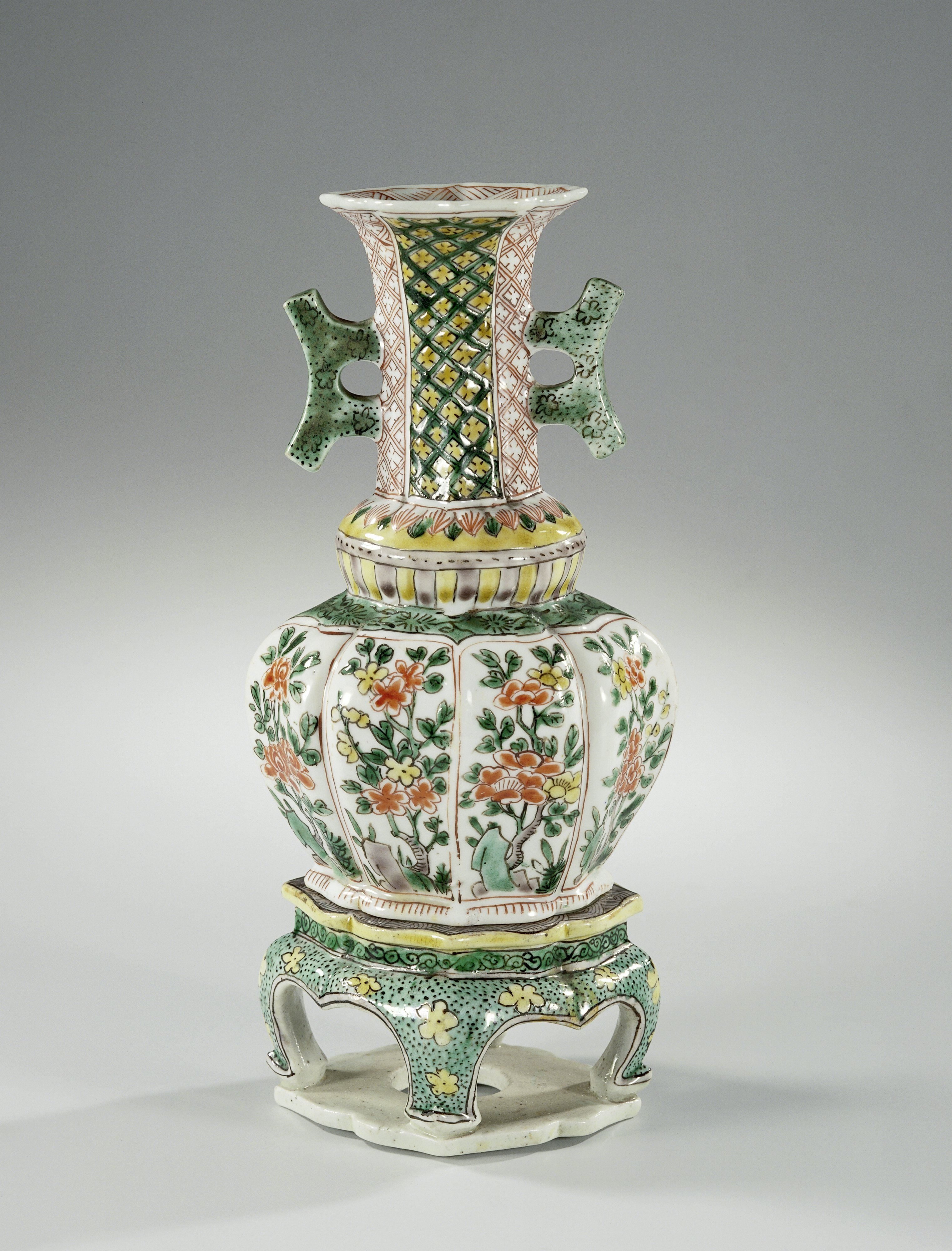 Octagonal vase with two handles, flowering plants and diaper pattern on a seperate stand
