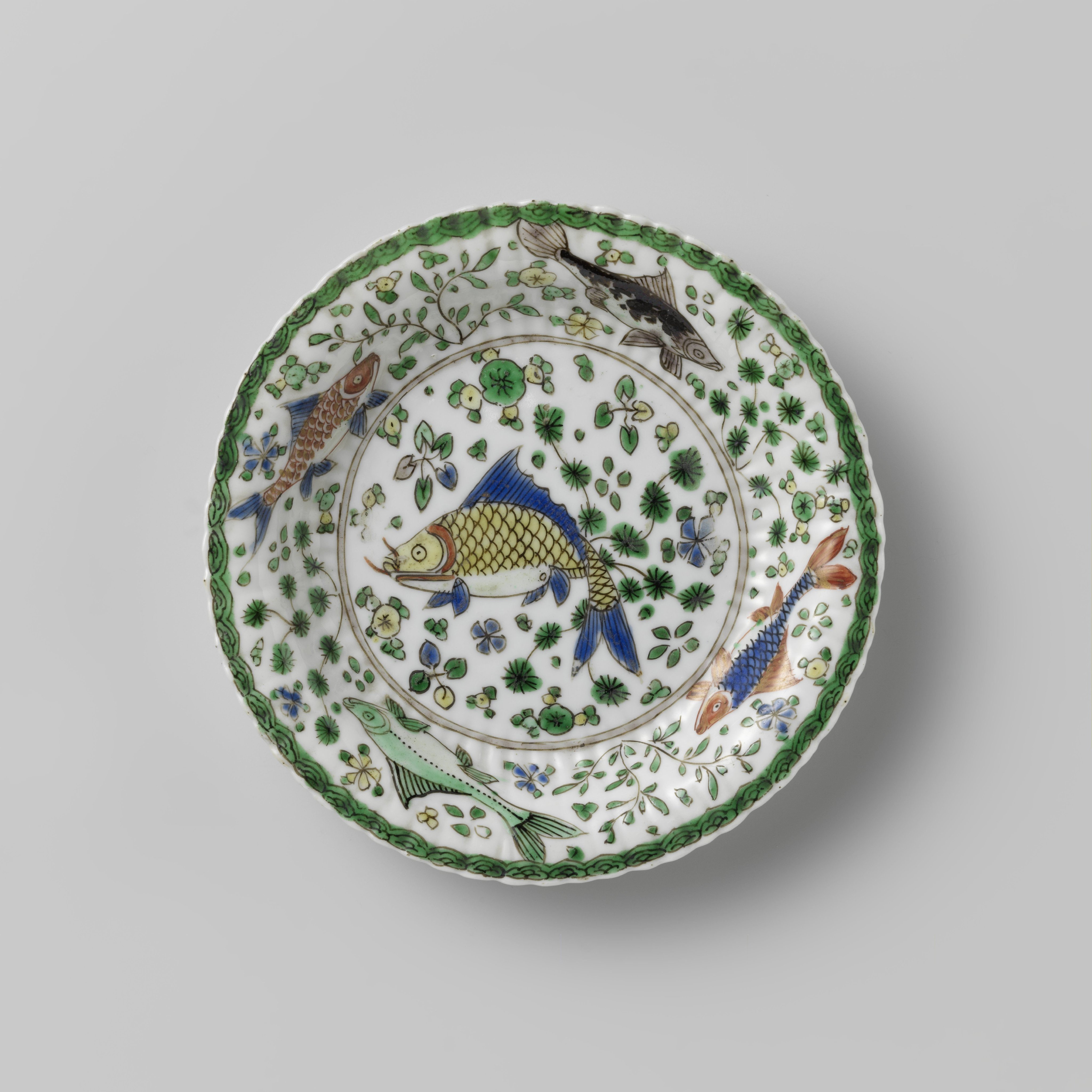 Cup and saucer with fish between water plants