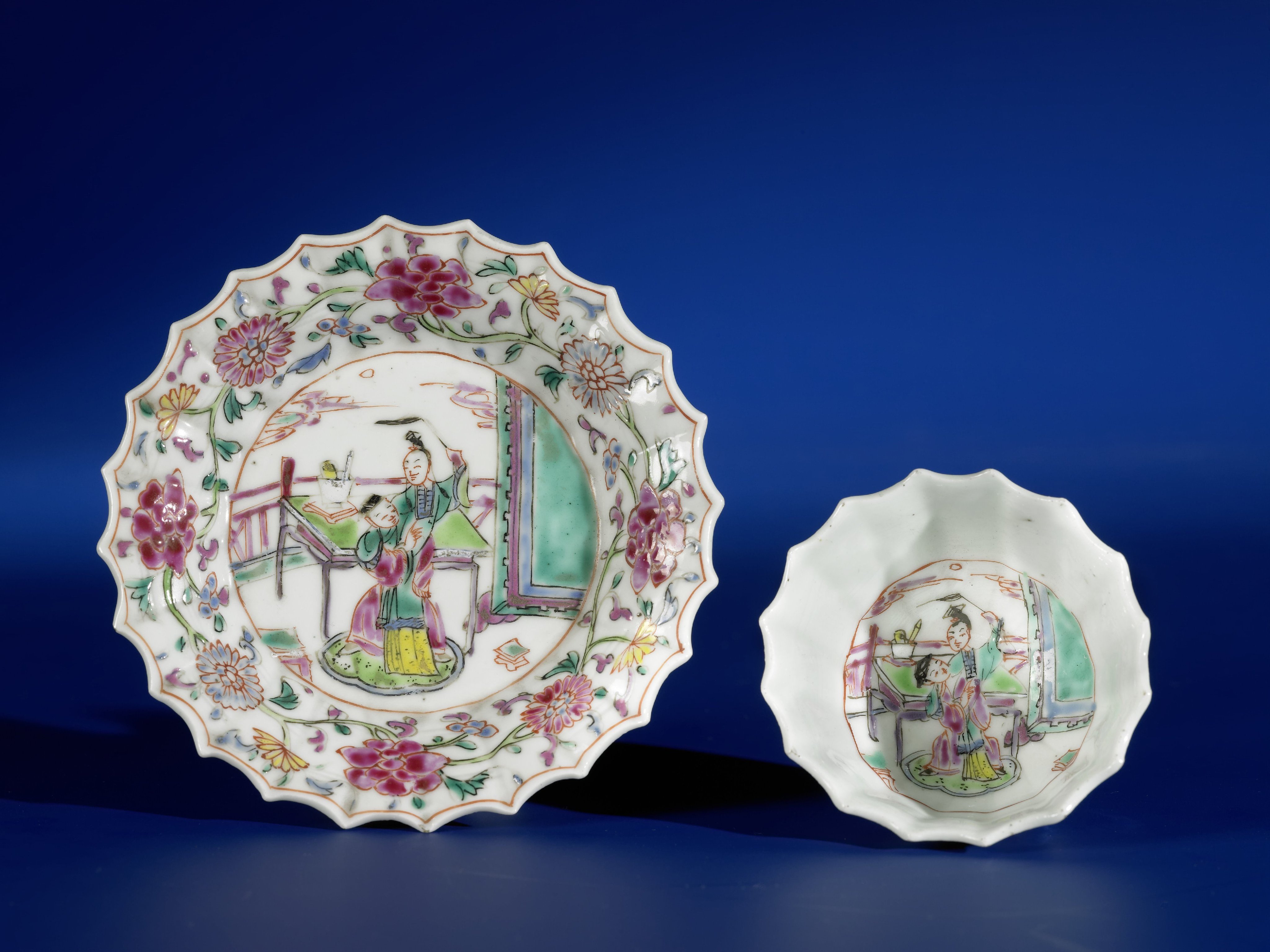 Bell-shaped cup and saucer with a man and woman on a terrace