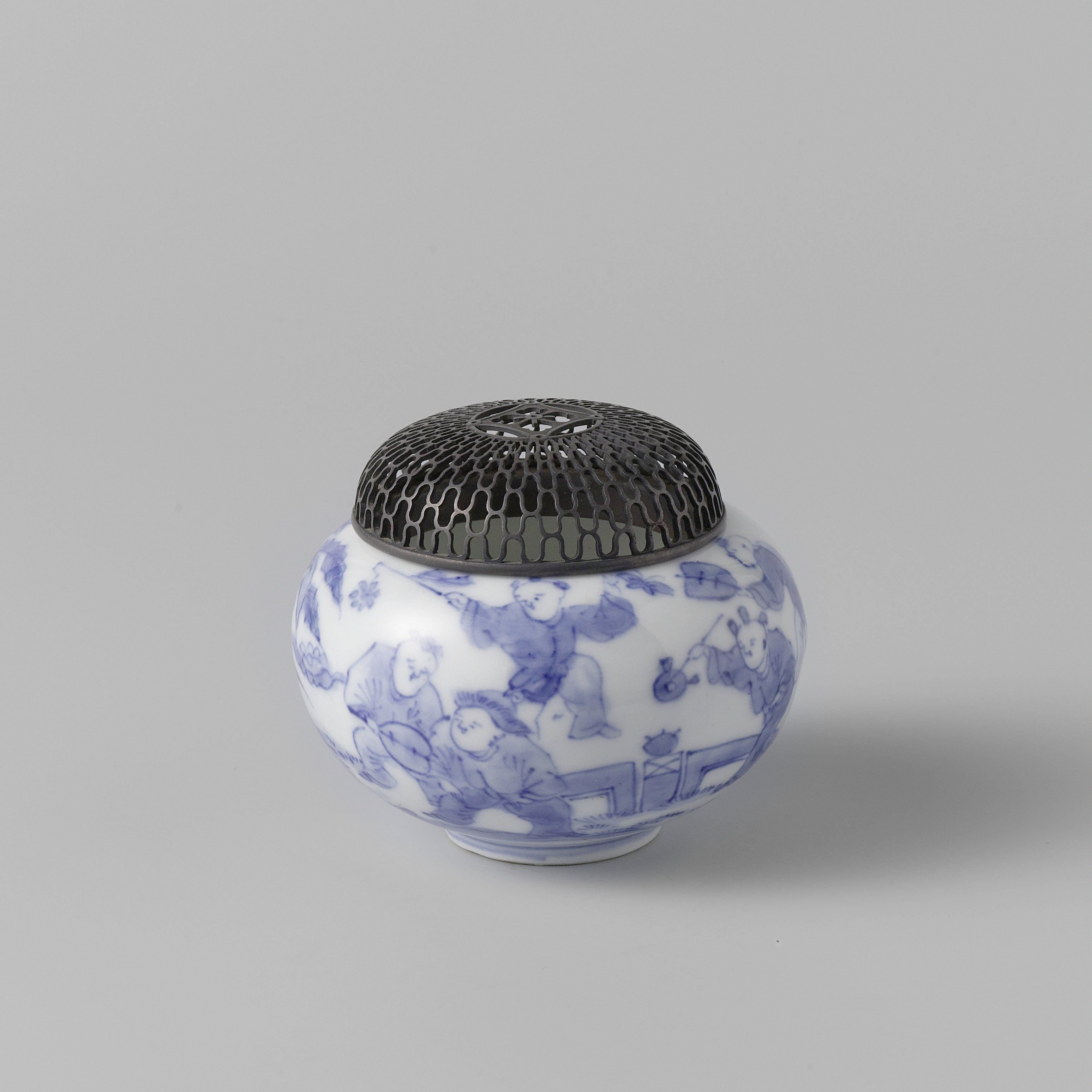 Incense burner with playing boys in a fenced garden and a metal cover