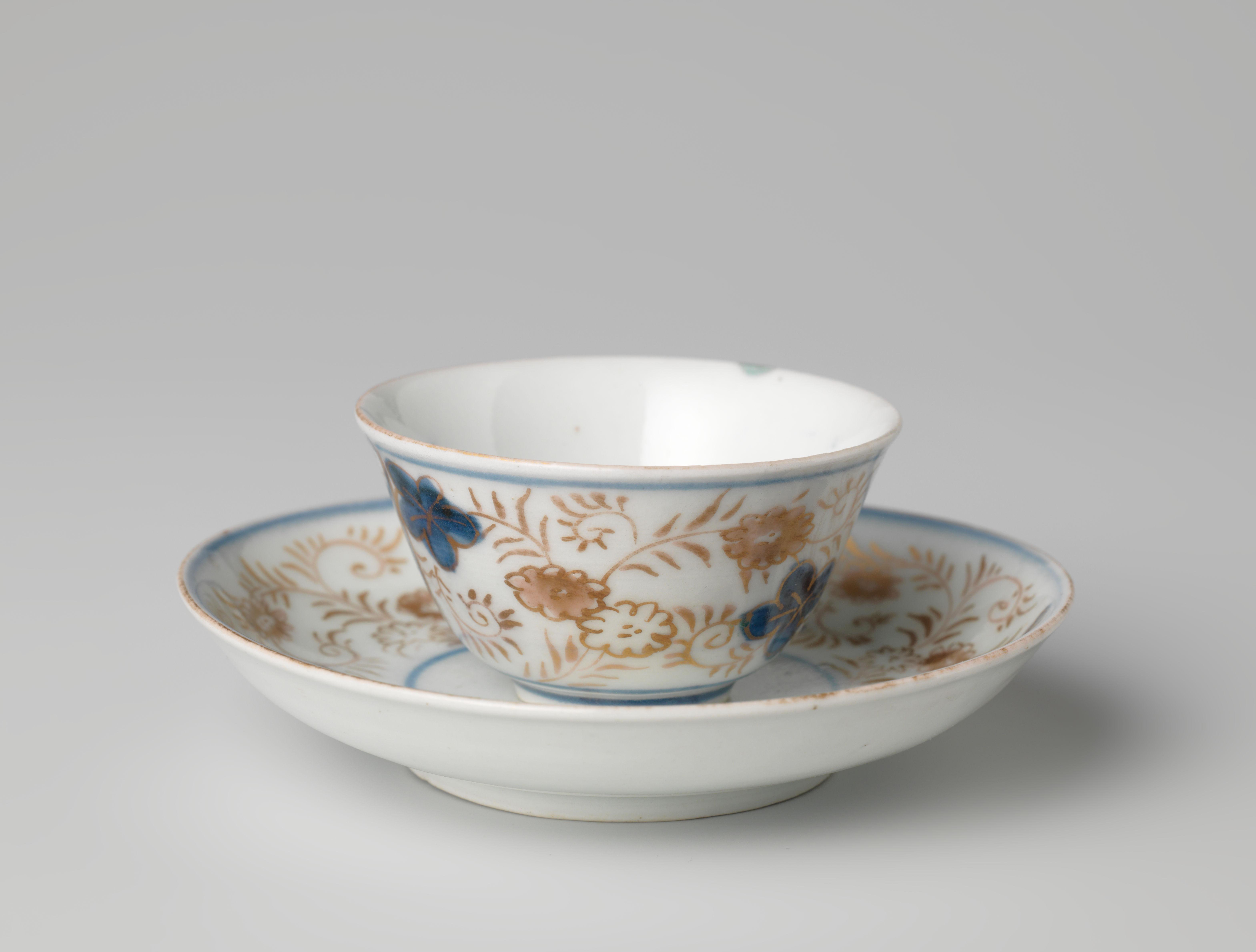 Bell-shaped cup and saucer with a flower basket and floral scrolls