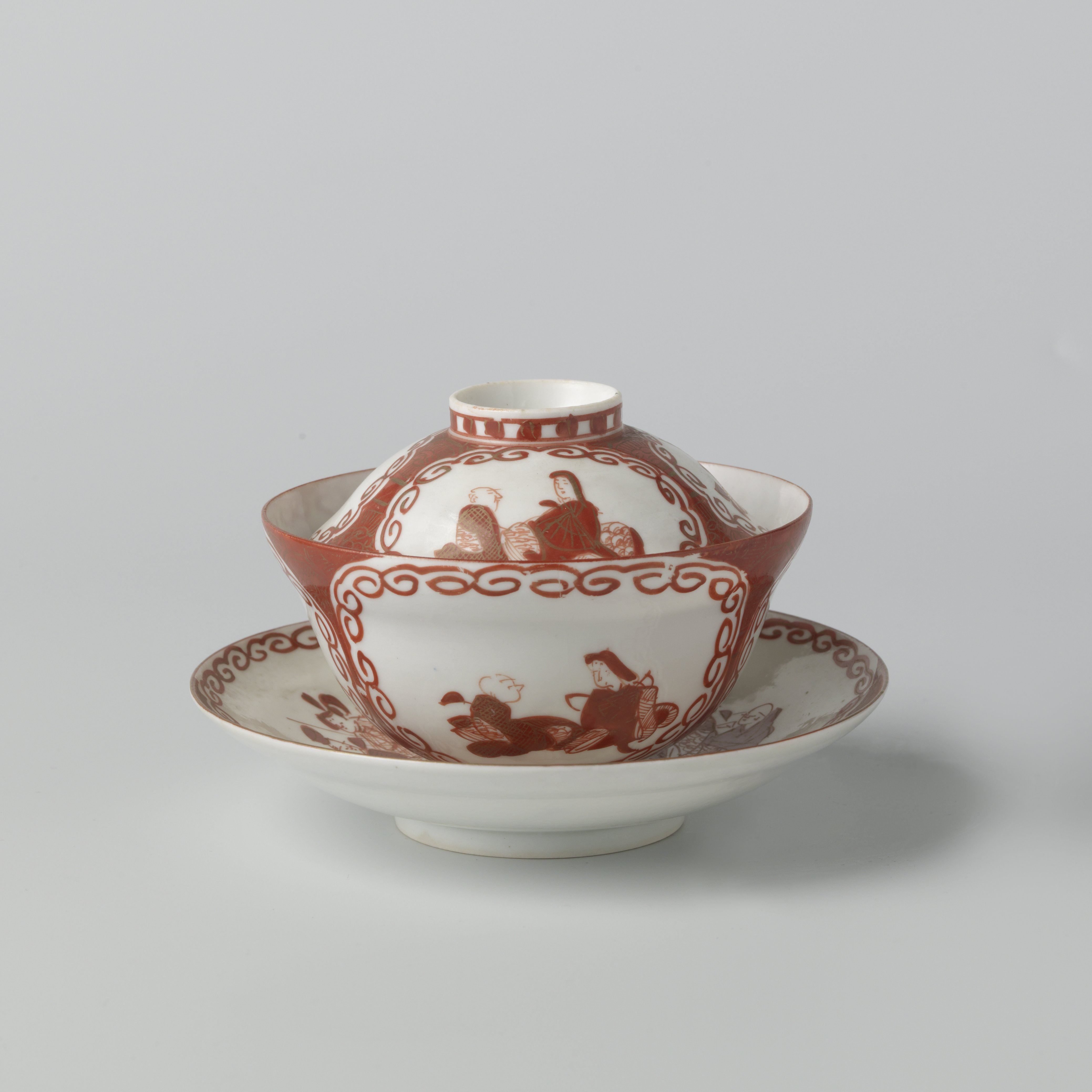 Covered cup and saucer with three panels with two seated figures