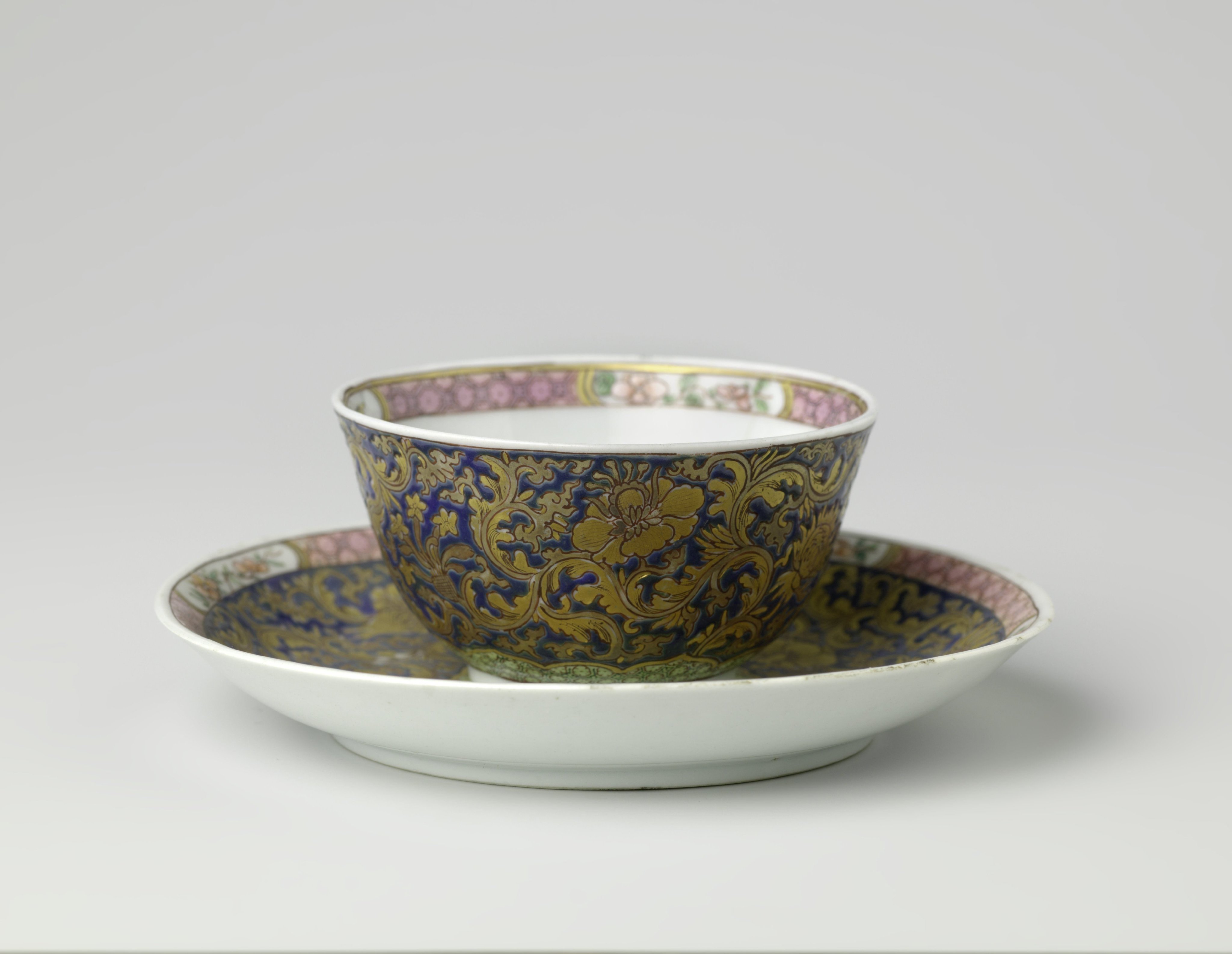 Cup and saucer and teapot stand with large floral scrolls, diaper pattern and flower sprays