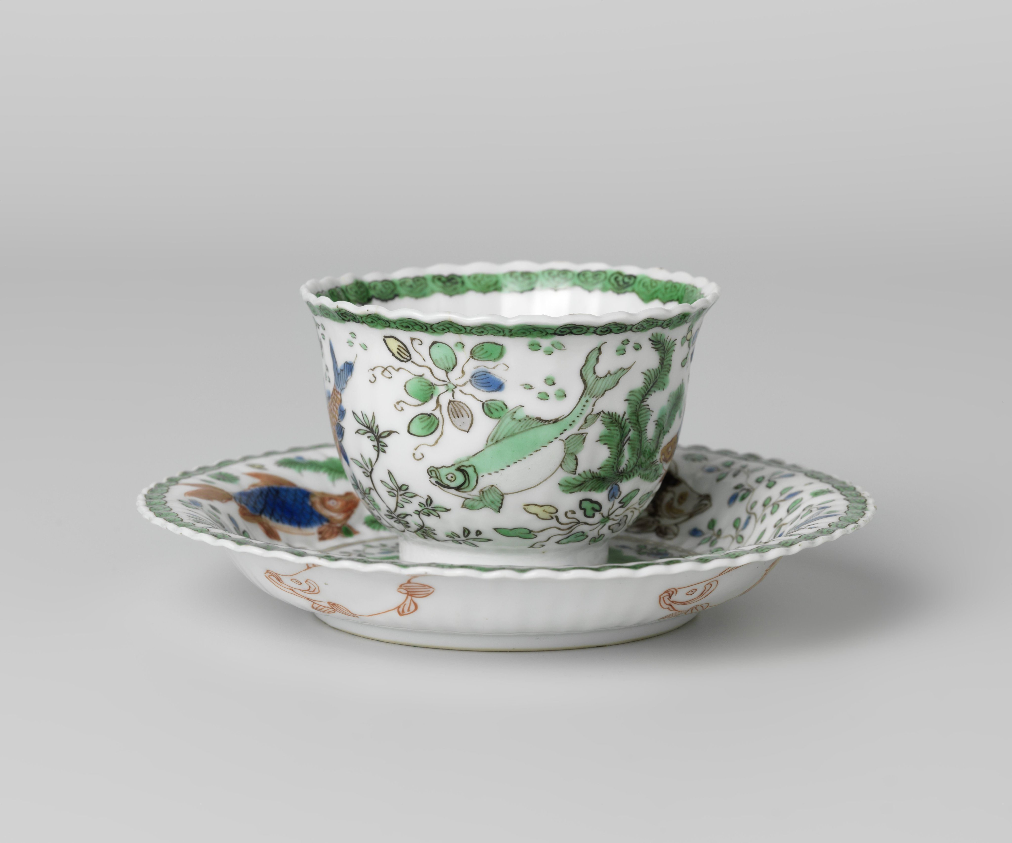Cup and saucer with fish between water plants