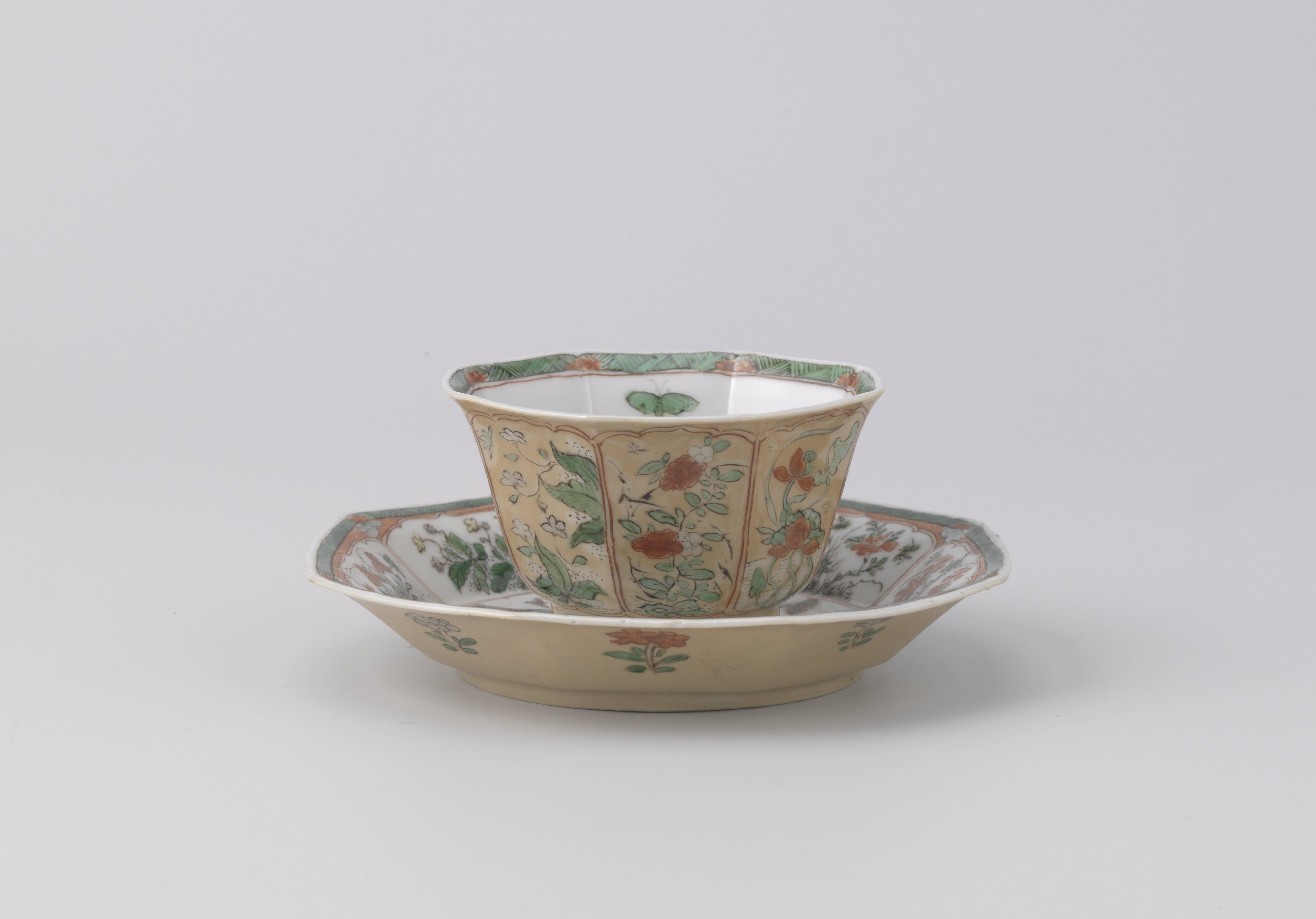Octagonal cup and saucer with light brown, animals and flower sprays