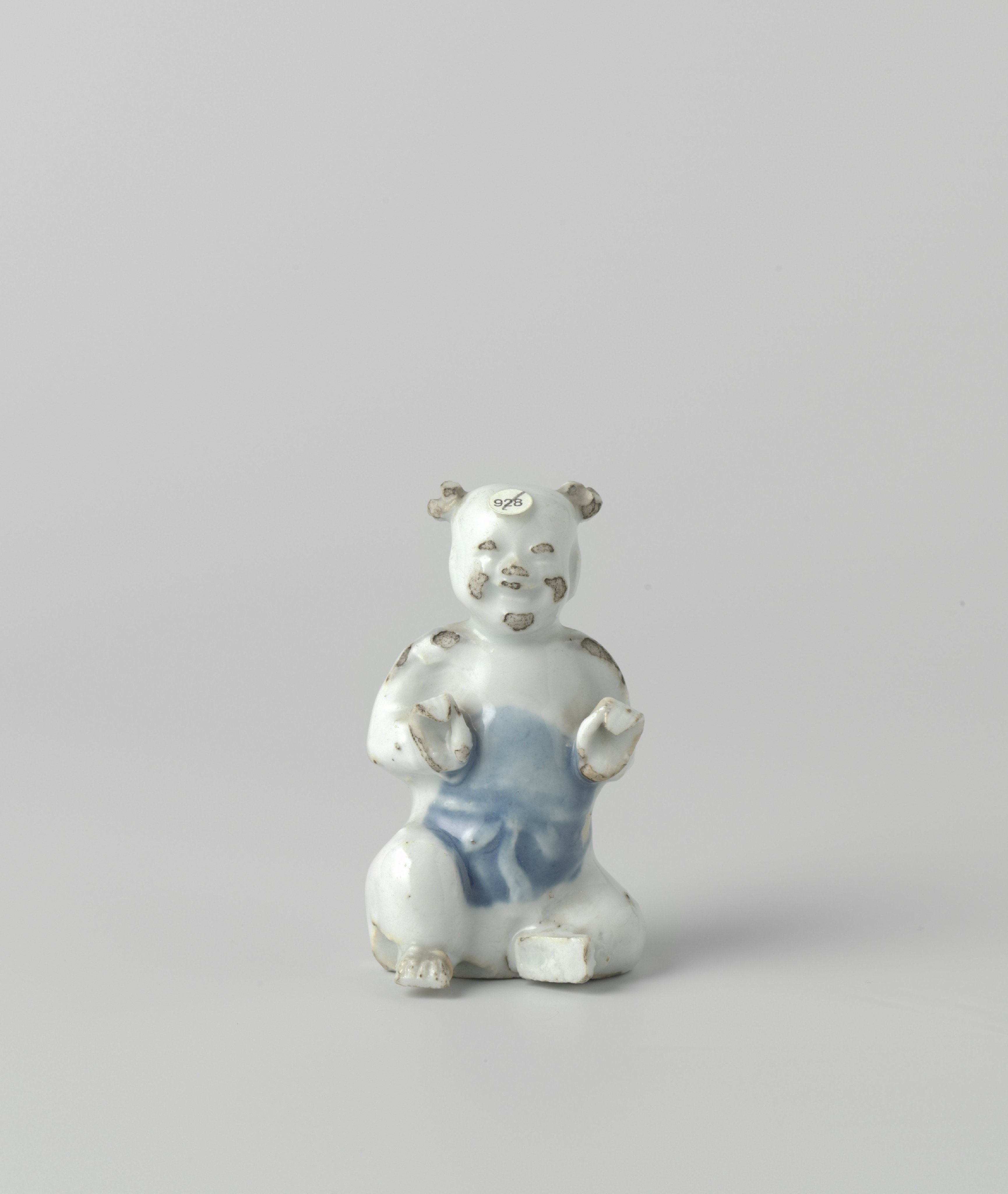 Figure of a seated boy