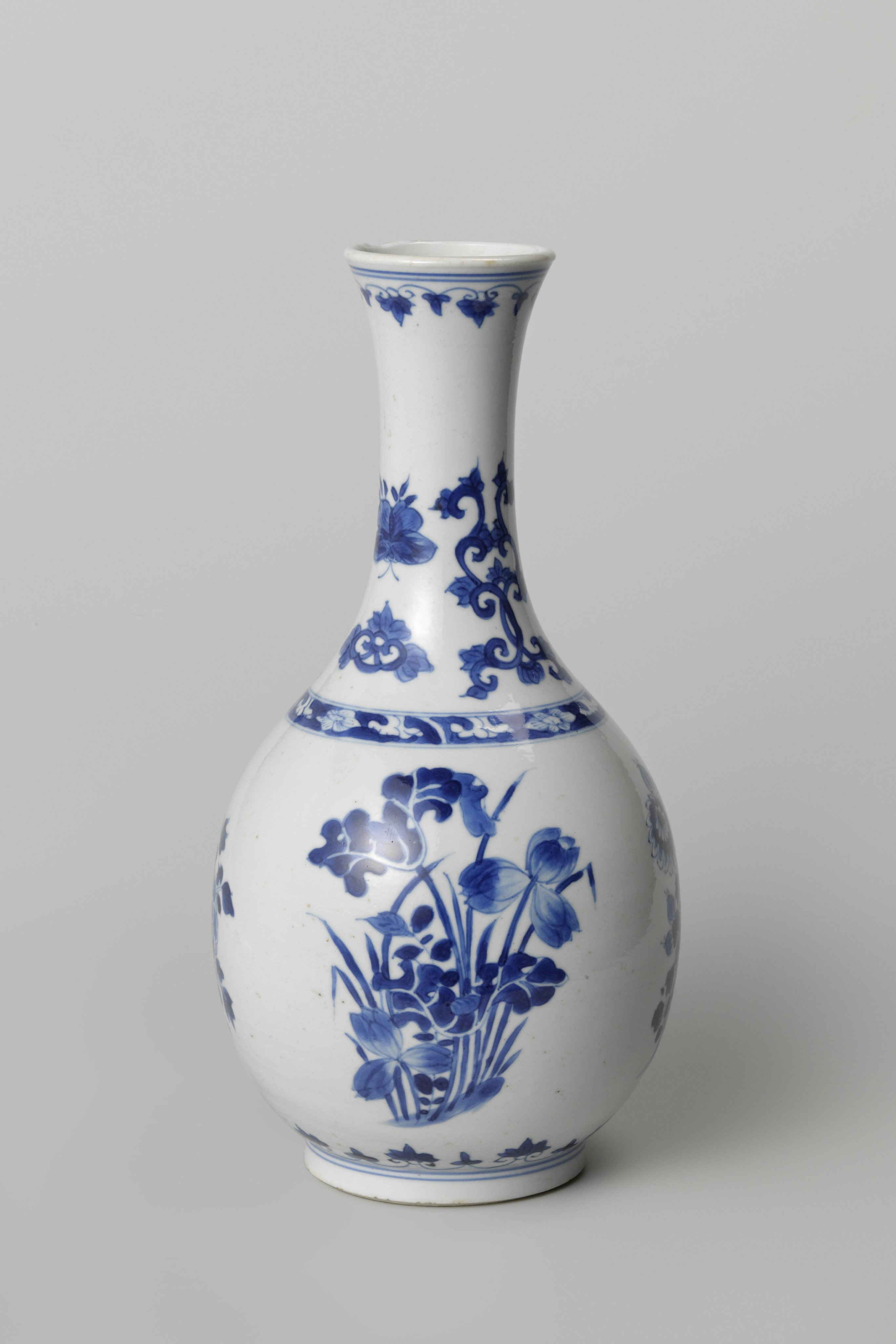Pear-shaped bottle vase with flowering plants