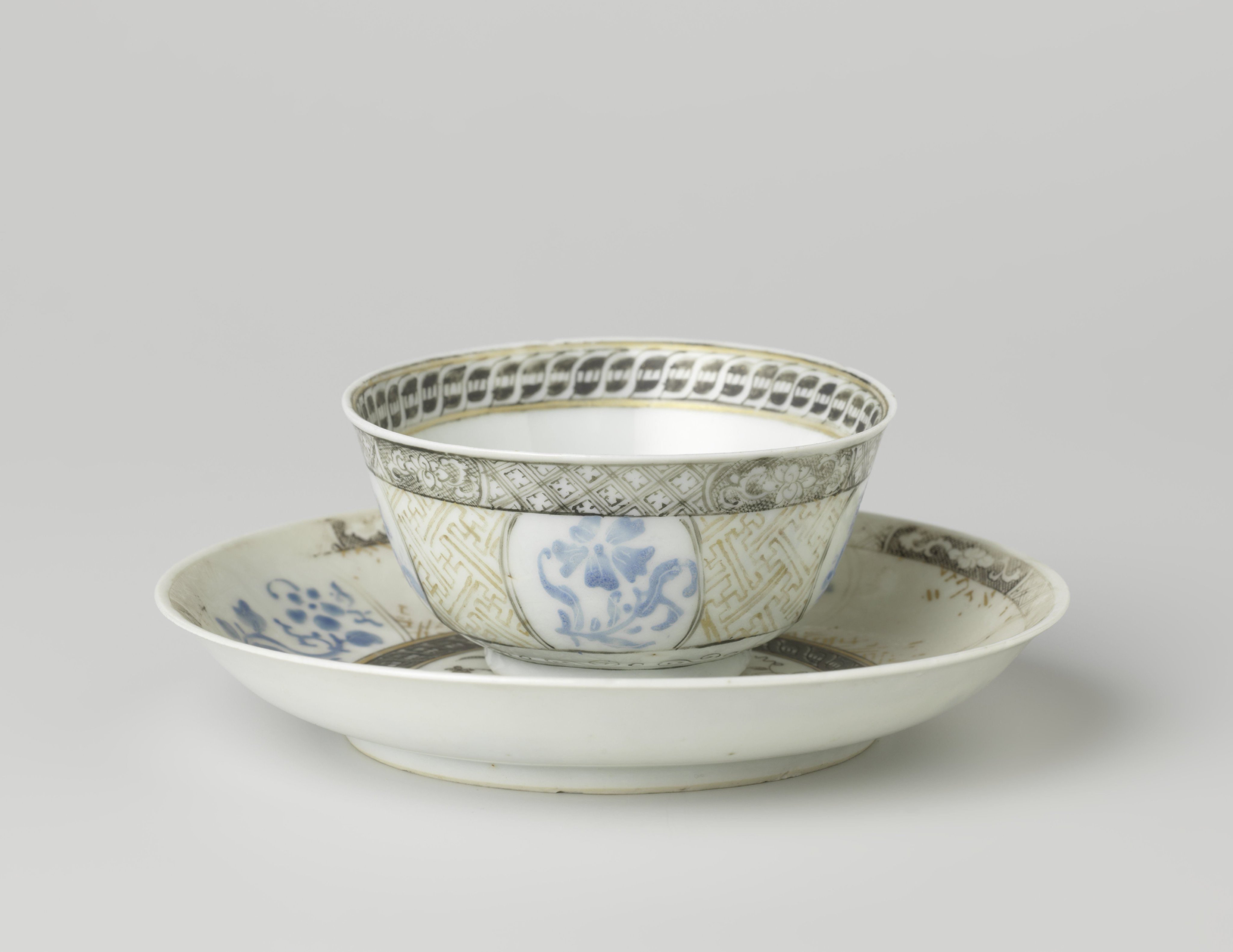 Bell-shaped cup and saucer with flower sprays and ornamental borders