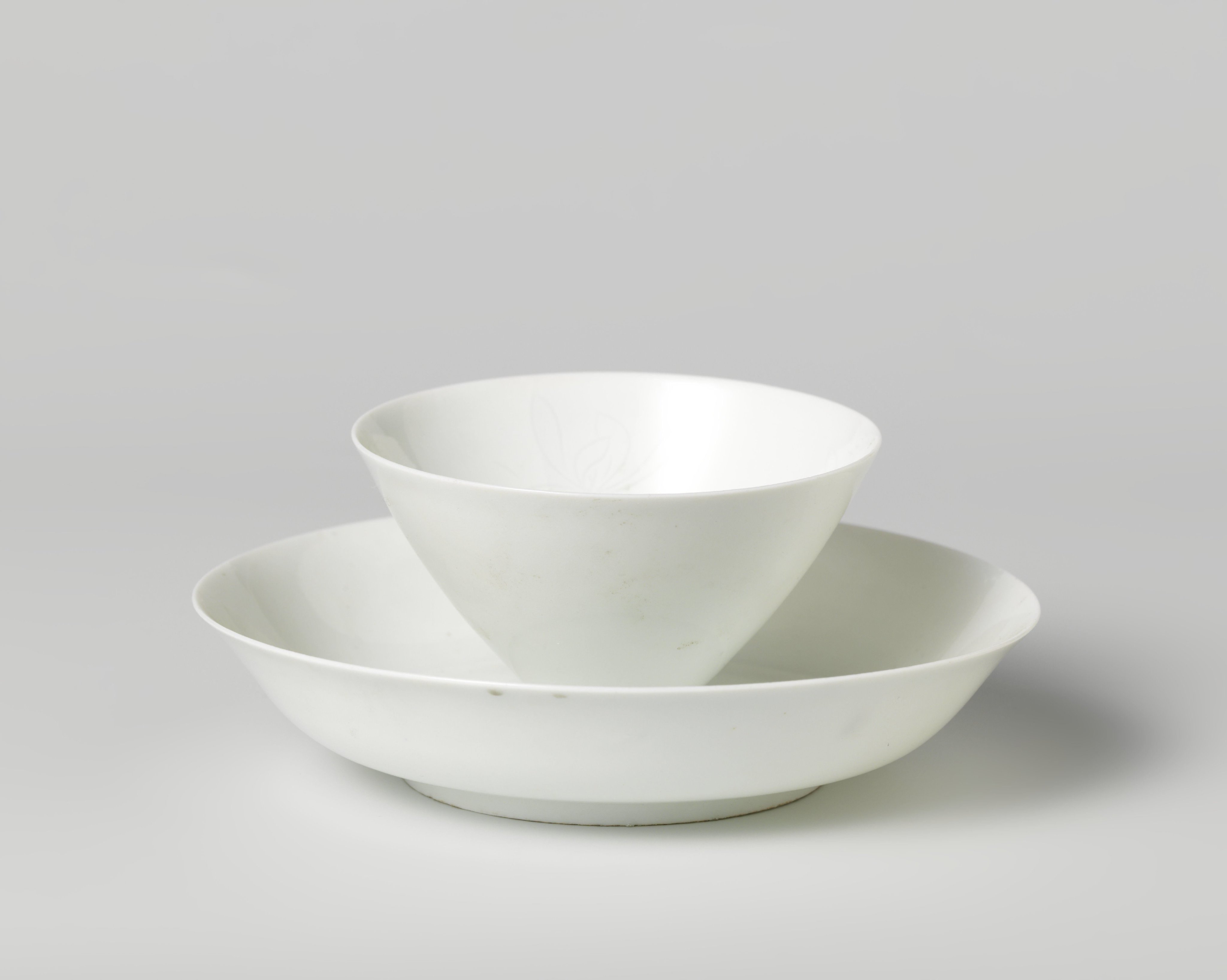 Cup and saucer with incised flower heads