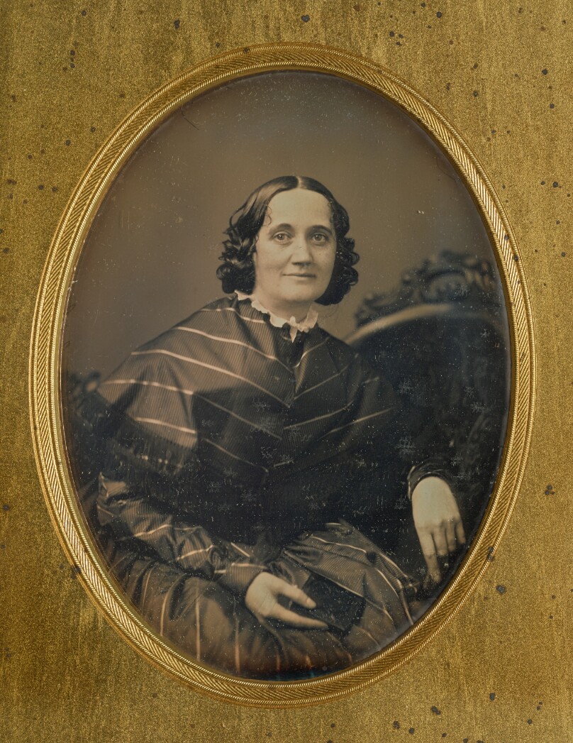 [Portrait of a woman holding a book]