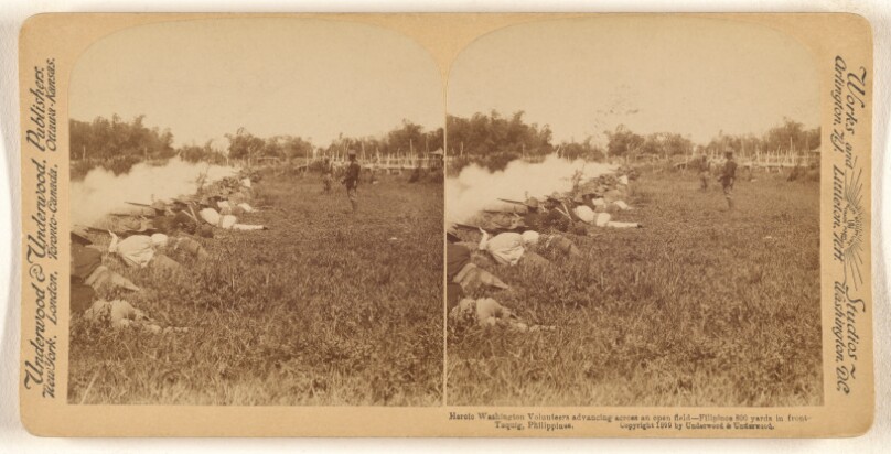 Heroic Washington Volunteers advancing across an open field - Filipinos 800 yards in front - Taquig, Philippines.