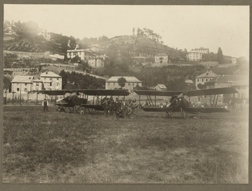 [Group portrait with two airplanes]