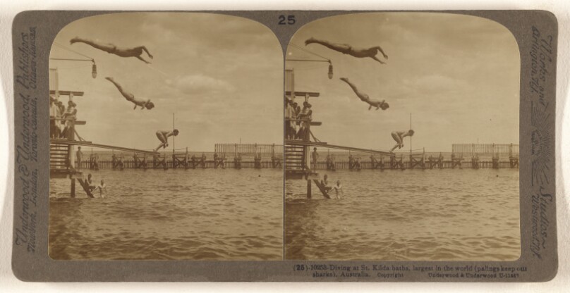 Diving at St. Kilda baths, largest in the world (palings keep out sharks), Australia.