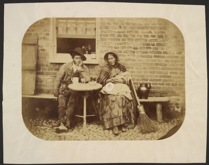 [Man and woman sitting at table]