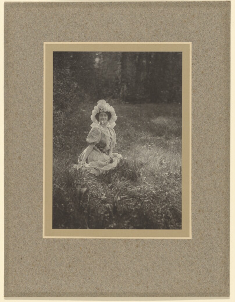 [Woman sitting in field]