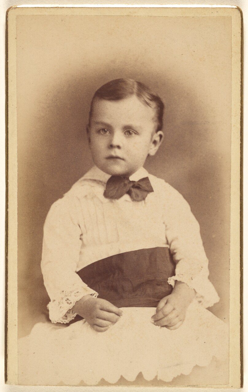 [Unidentified little boy wearing a bow tie, seated]