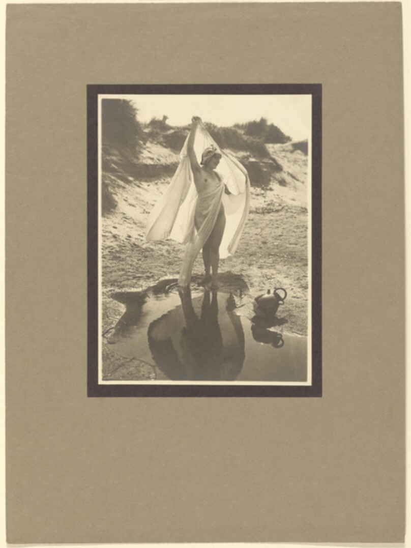 [Draped female nude on beach]