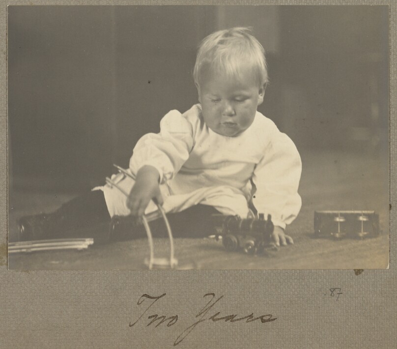 [Chandler Weston playing with a toy train]