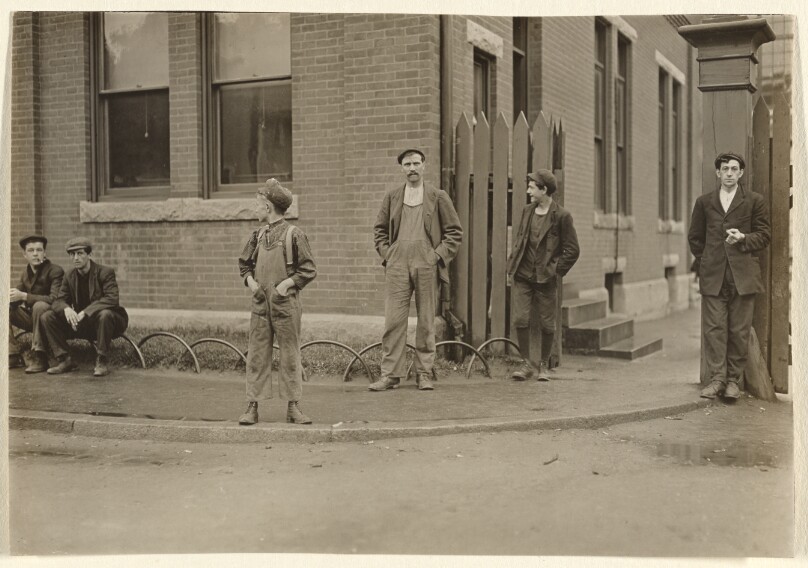 [Group of men and boys gathered outside]