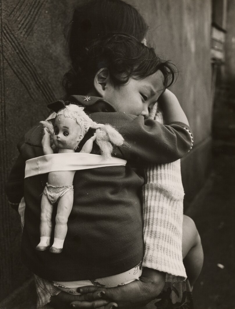 Girl Being Carried with Doll on Her Back