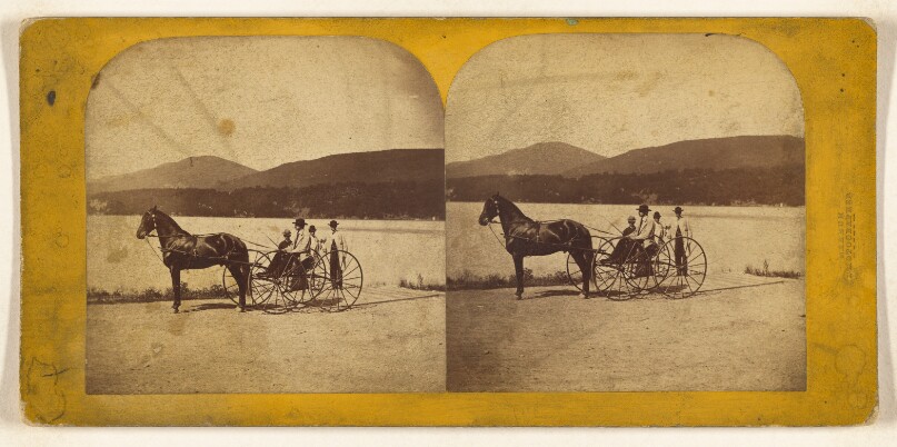 [Man with hat seated in horse-drawn carriage, three men behind him]
