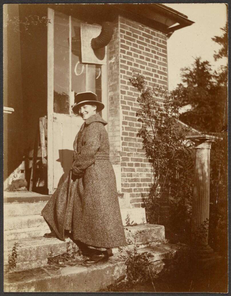 [Woman walking up steps]
