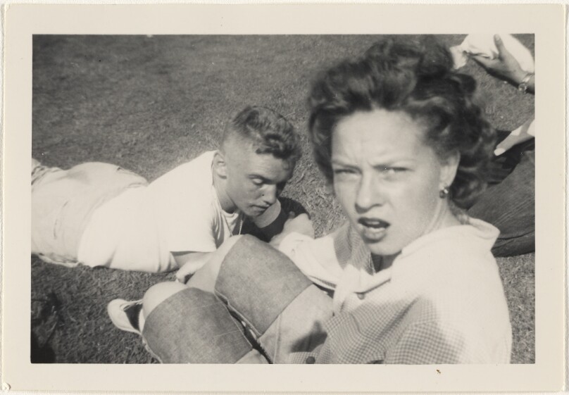 [Young man and woman on grass]