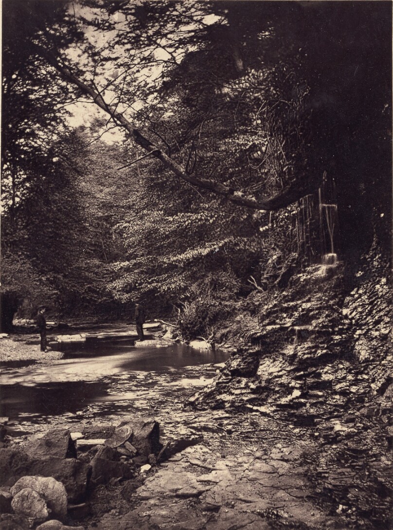 [Two men on banks of stream]