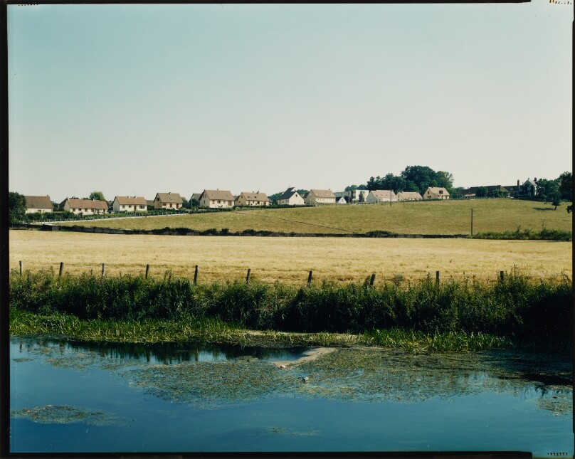 [River landscape with houses in distance]