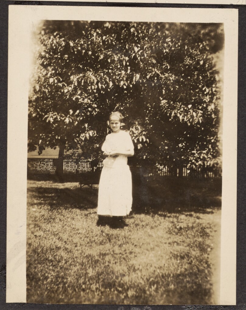[Girl standing on a lawn]