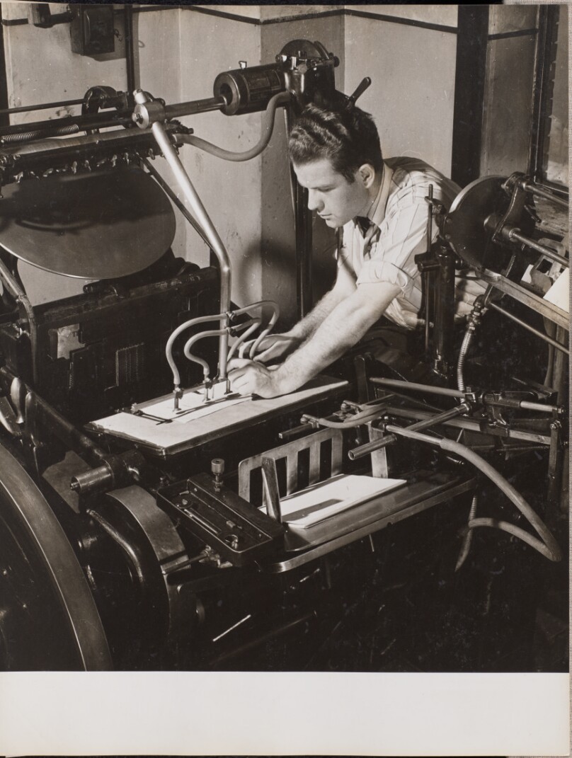 [Man adjusts tubes on a printing press]