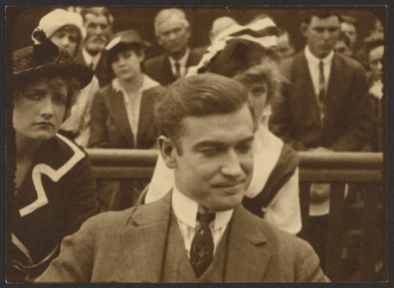 [Film still of man in courtroom]