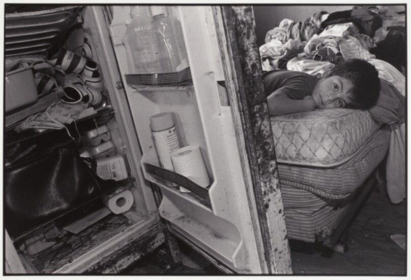Boy on Bed & Junk in Icebox, Rural Poverty