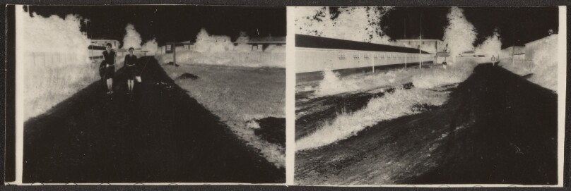 [Contact print from two 37 mm film positives: strollers on path alongside long building in negative]