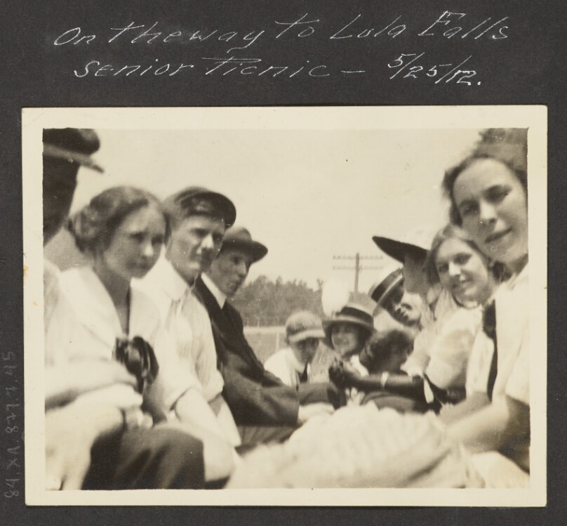 [View of Men and Women Sitting in Carriage]