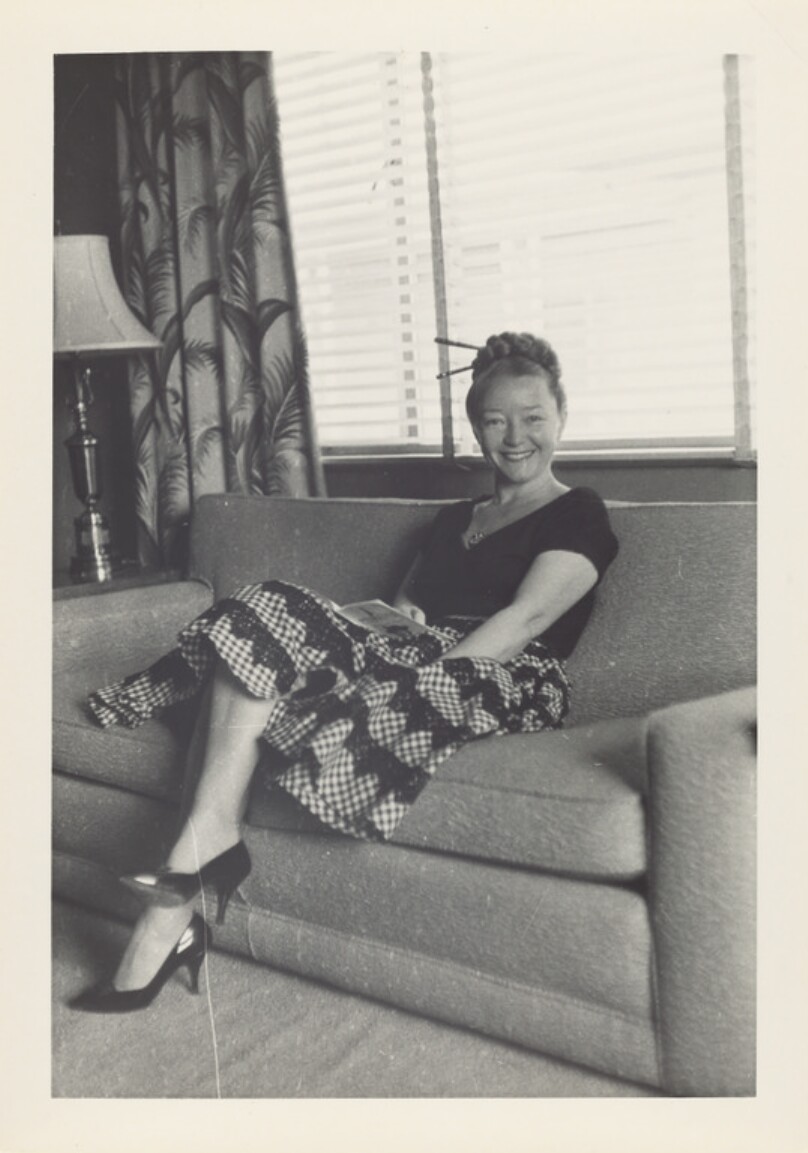 [Woman sitting on sofa]